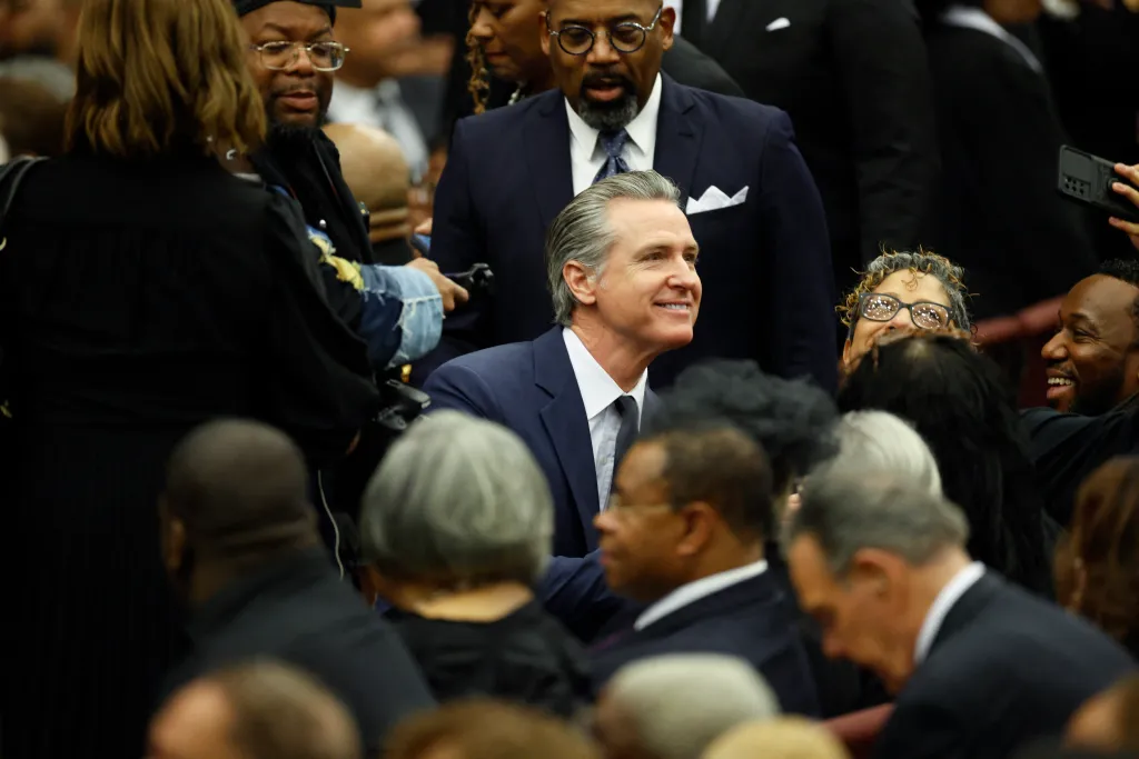 California Governor Gavin Newsom smiles while greeting attendees during the Public Homecoming and celebration of life for civil rights activist Reverend Jesse Jackson.
