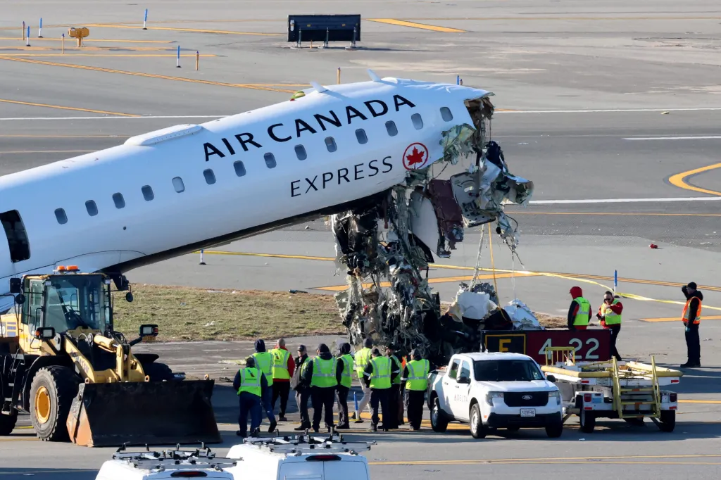 Investigators examine the wreckage of an Air Canada Express jet at LaGuardia Airport in Queens on March 24, 2026.