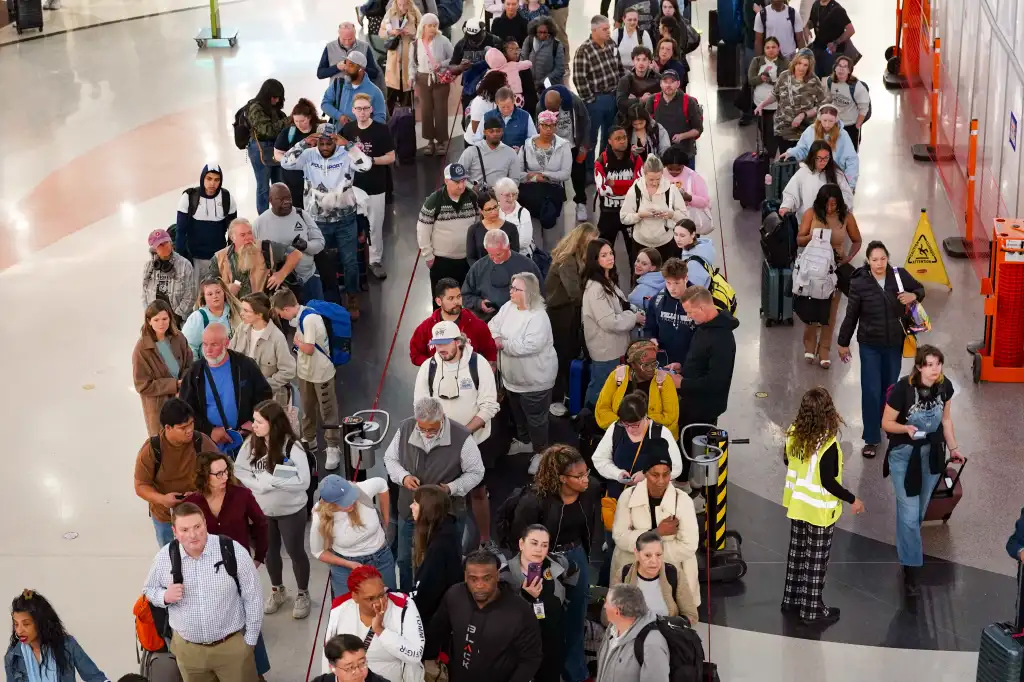 Travelers in long lines at Atlanta Hartsfield-Jackson International Airport due to government shutdown.