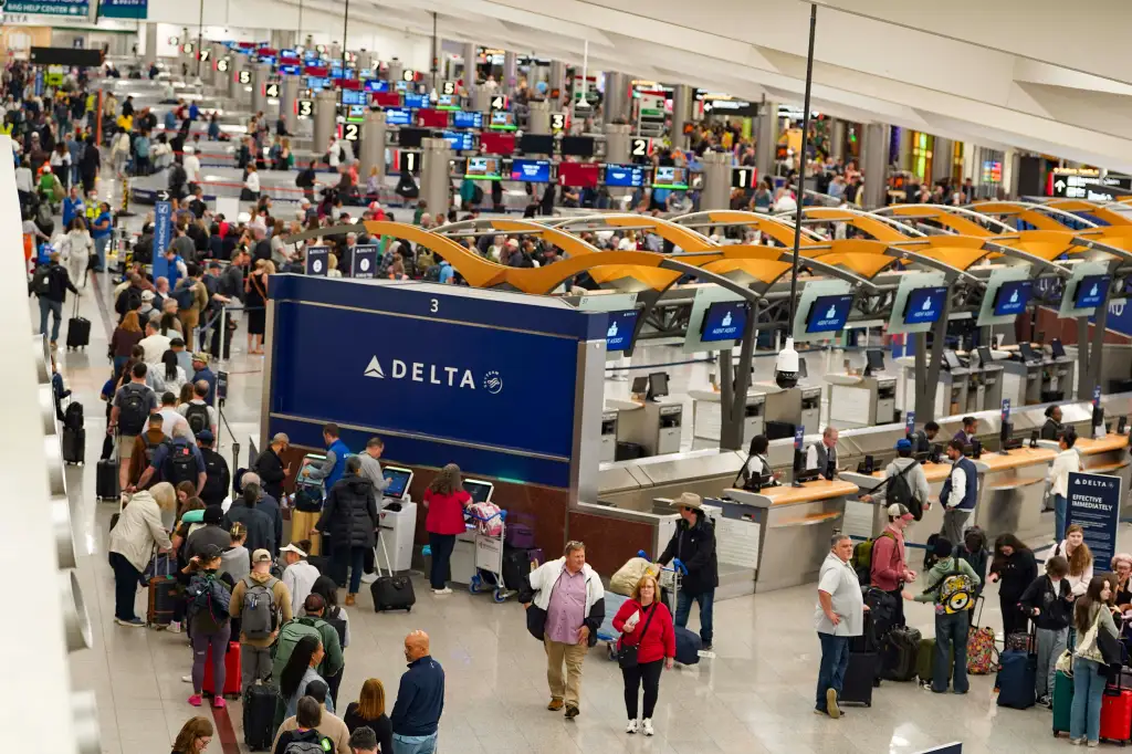 Travelers waiting in long lines at Atlanta Hartsfield-Jackson International Airport.