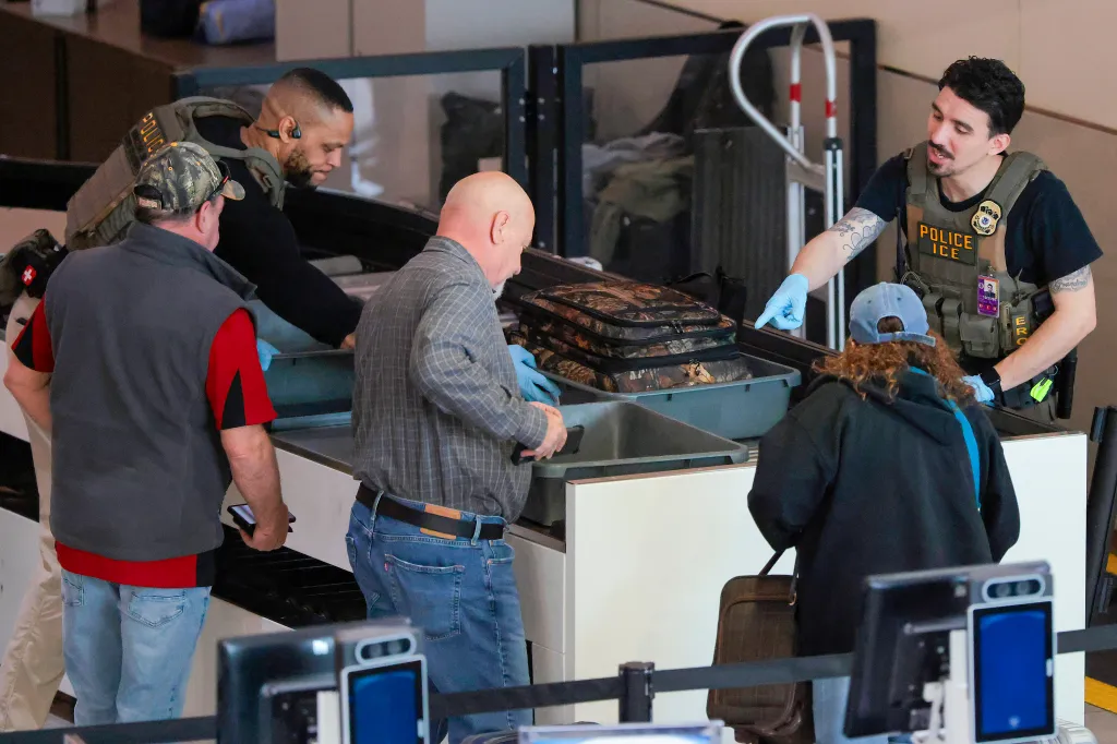 ICE agents assisting travelers through airport security.