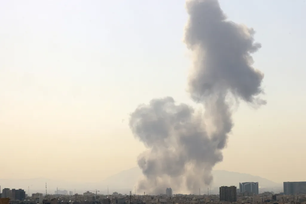 Smoke rising above buildings in central Tehran following an Israeli attack.