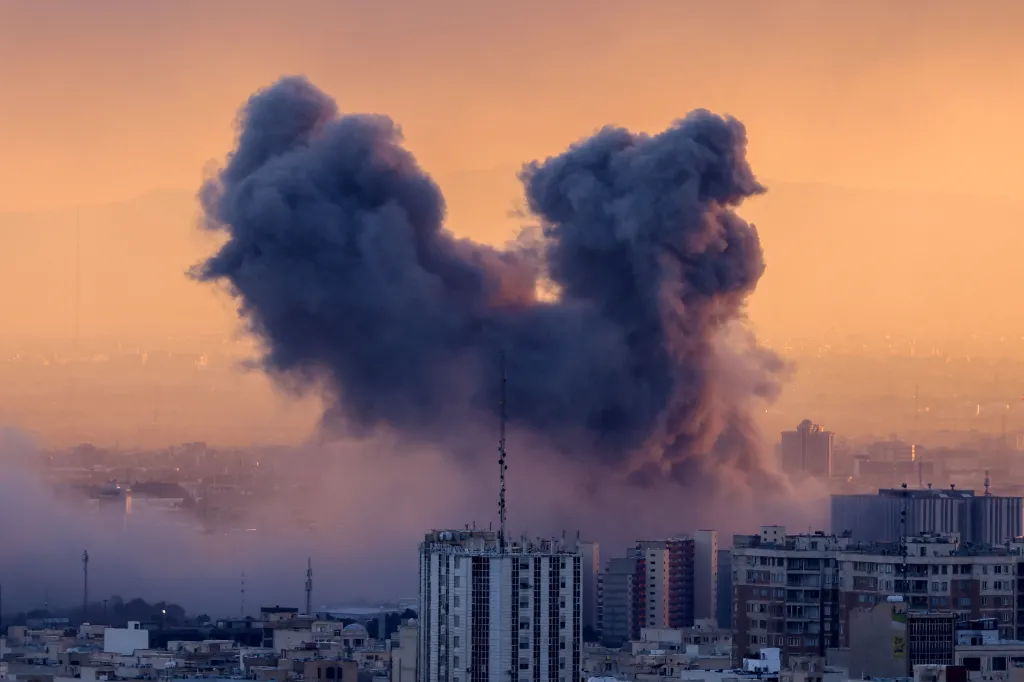 Plume of smoke rising over Tehran after a strike.
