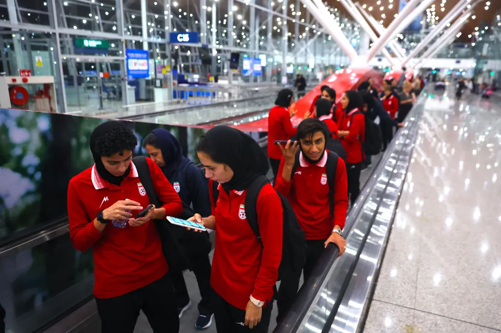 Iranian women's national soccer team members arriving at Kuala Lumpur International Airport.