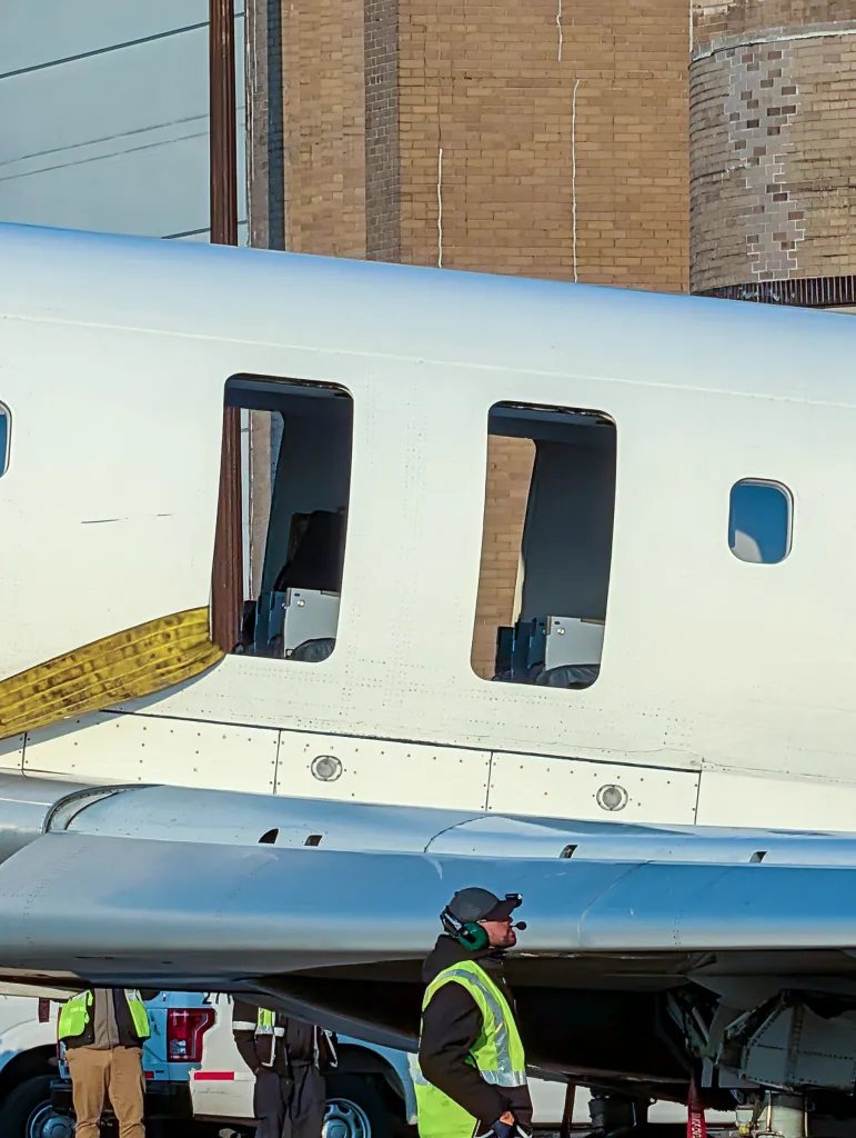 An Air Canada plane is being moved to a hanger to unload passenger belongings.