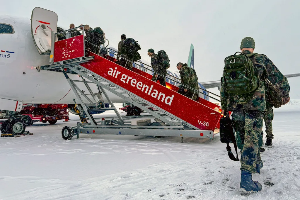 Military personnel board an Air Greenland flight in Nuuk, Greenland.