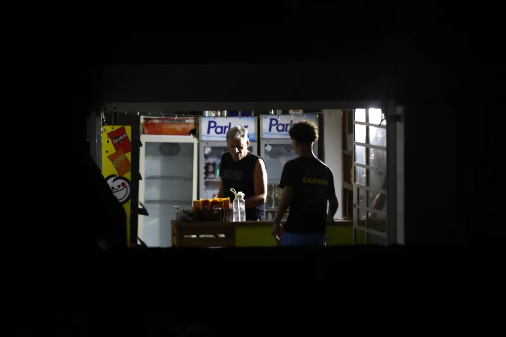 Two men in a market during a power outage in Havana, Cuba.