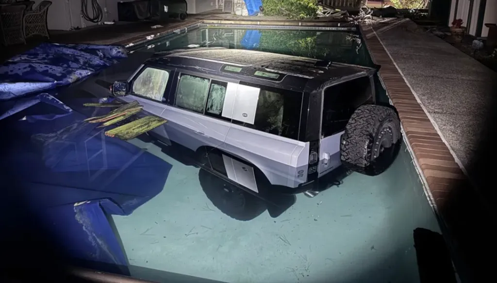 Land Rover Defender crashed into a backyard swimming pool.