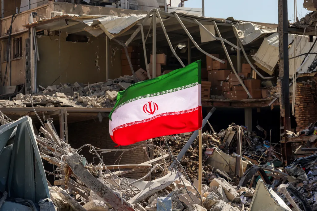Iranian flag placed amidst rubble and debris of a destroyed residential building in Tehran.