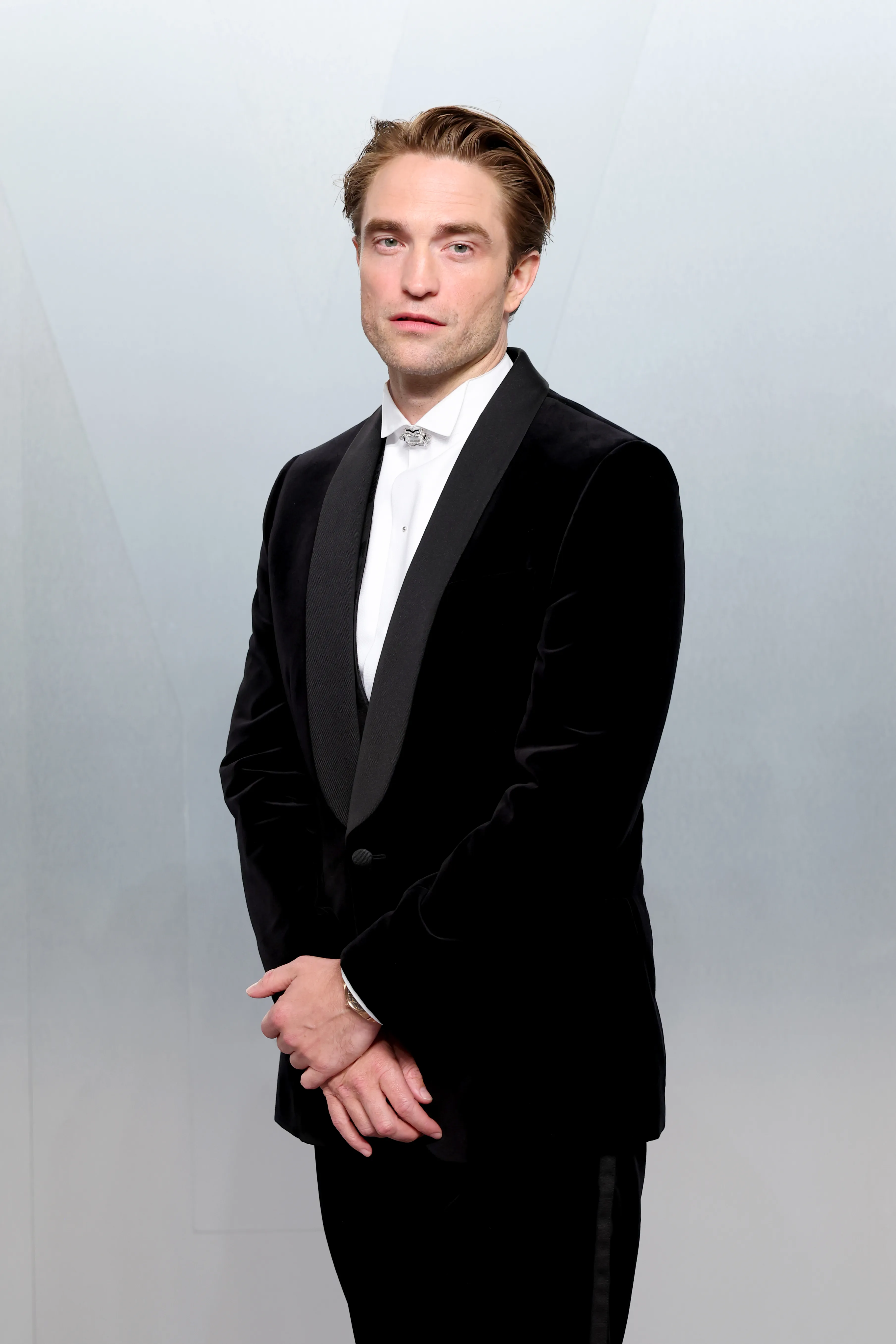 Robert Pattinson in a black velvet tuxedo.