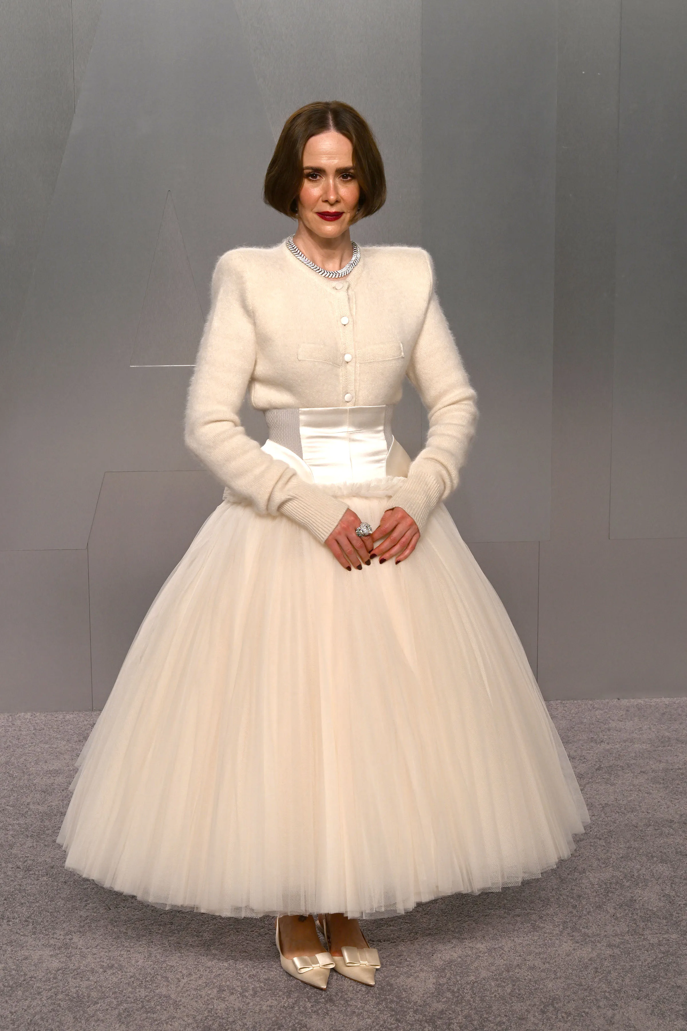 Sarah Paulson in a white cardigan and tulle skirt.