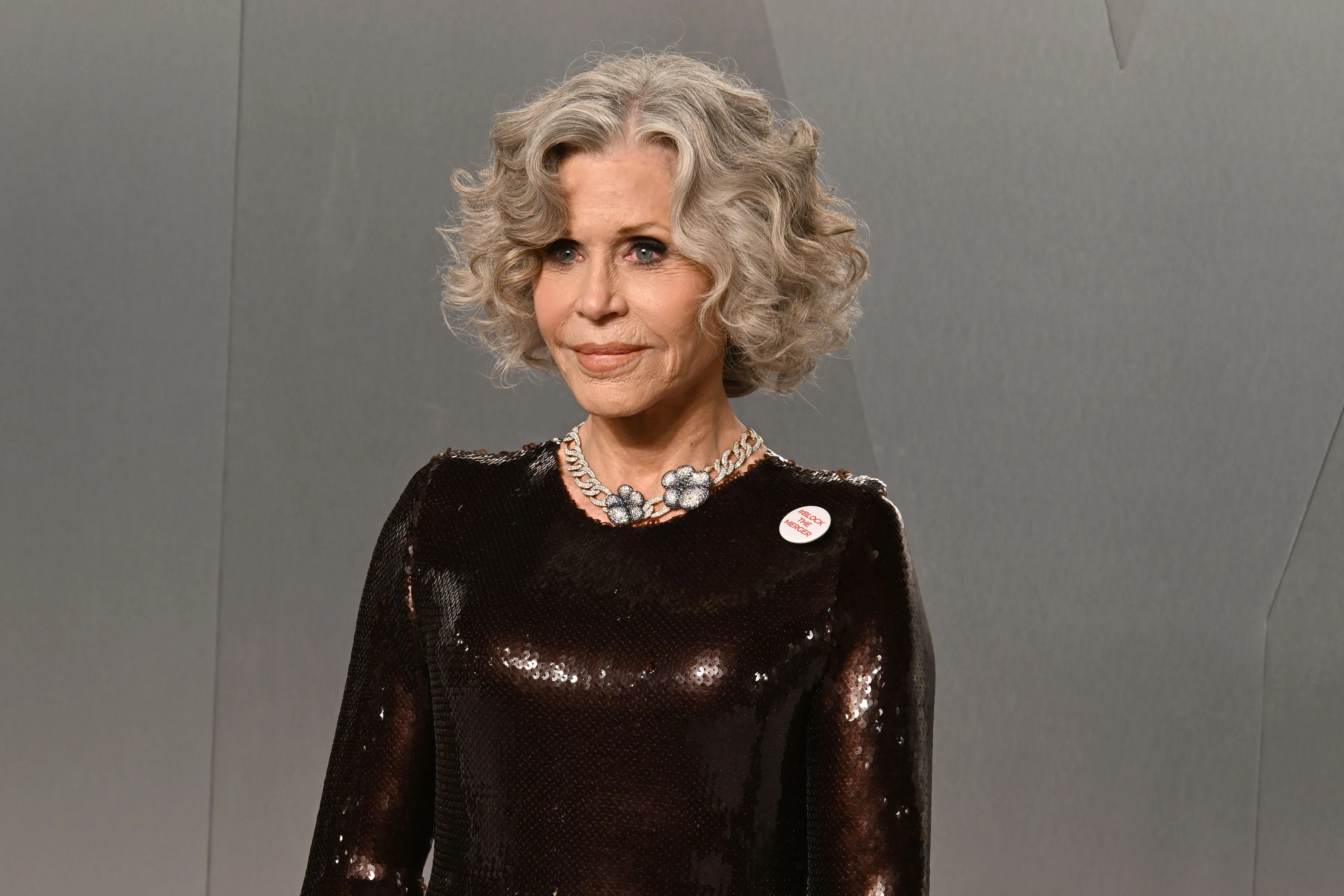 Jane Fonda with grey, curly hair and a dark, sequined dress at the 2026 Vanity Fair Oscar Party.