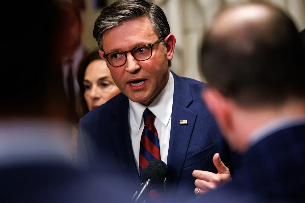U.S. Speaker of the House Mike Johnson speaks into a microphone during a press conference.