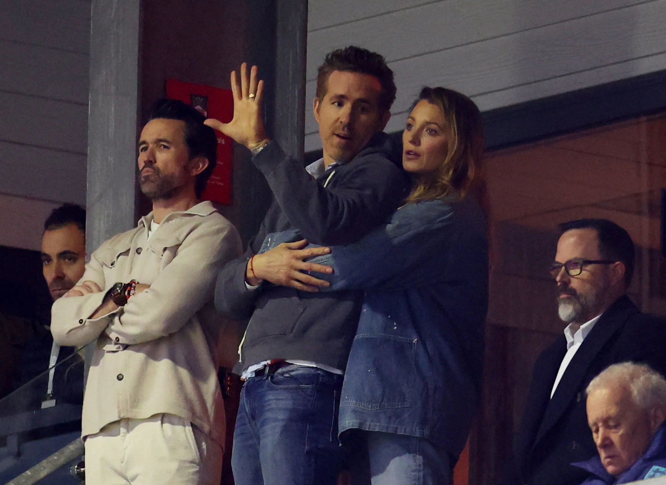 Rob McElhenney, Ryan Reynolds, and Blake Lively in the stands at the FA Cup Fifth Round match.