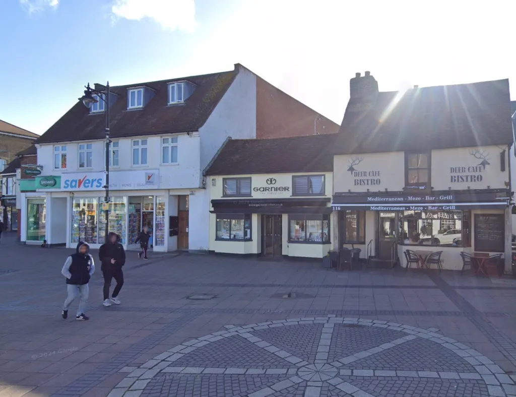 A sunny street view showing a row of shops including Garnier Jewellers and Deer Cafe Bistro.