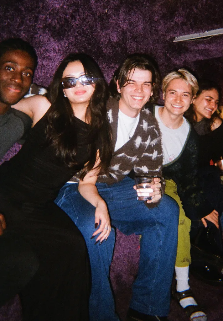 A group of young friends smiling at the camera at a 222 meet-up.