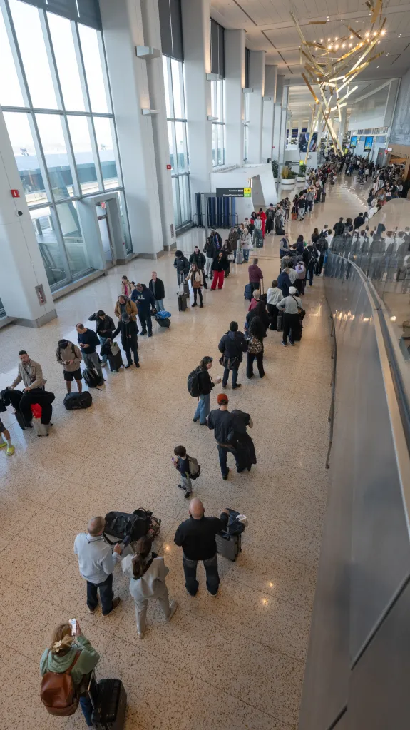 Passengers wait on long lines at LaGuardia Airport in Queens on March 21, 2026.