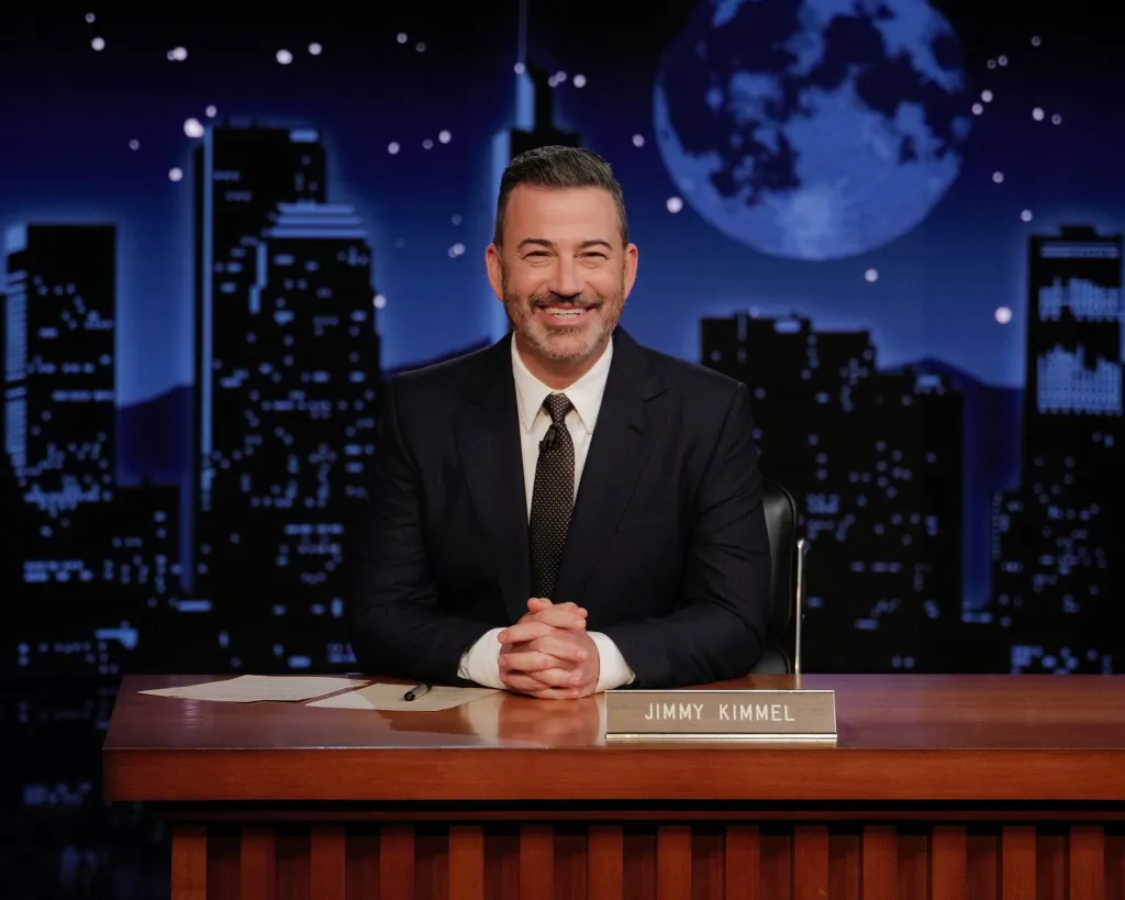 Jimmy Kimmel sits at his desk on the set of