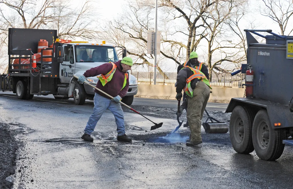 Road crew workers repairing a pothole.