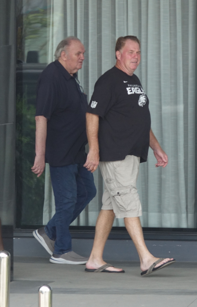 Thomas Markle and Tom Markle Junior walking outside an apartment building.