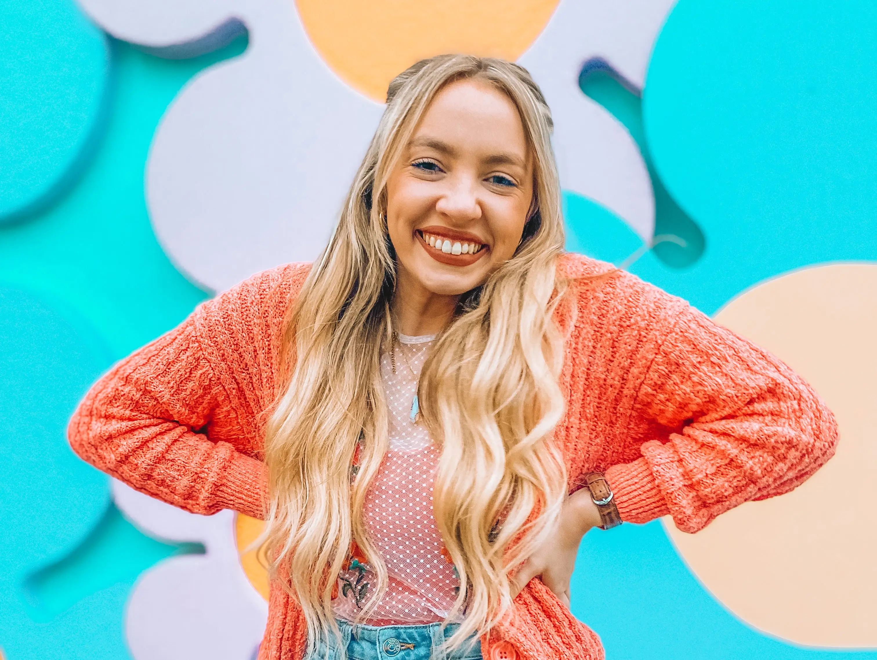 kayleigh posing in front of pastel flower statues at epcot