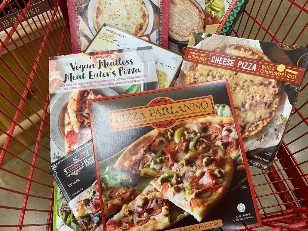 Trader Joe's frozen pizzas lined up in red cart