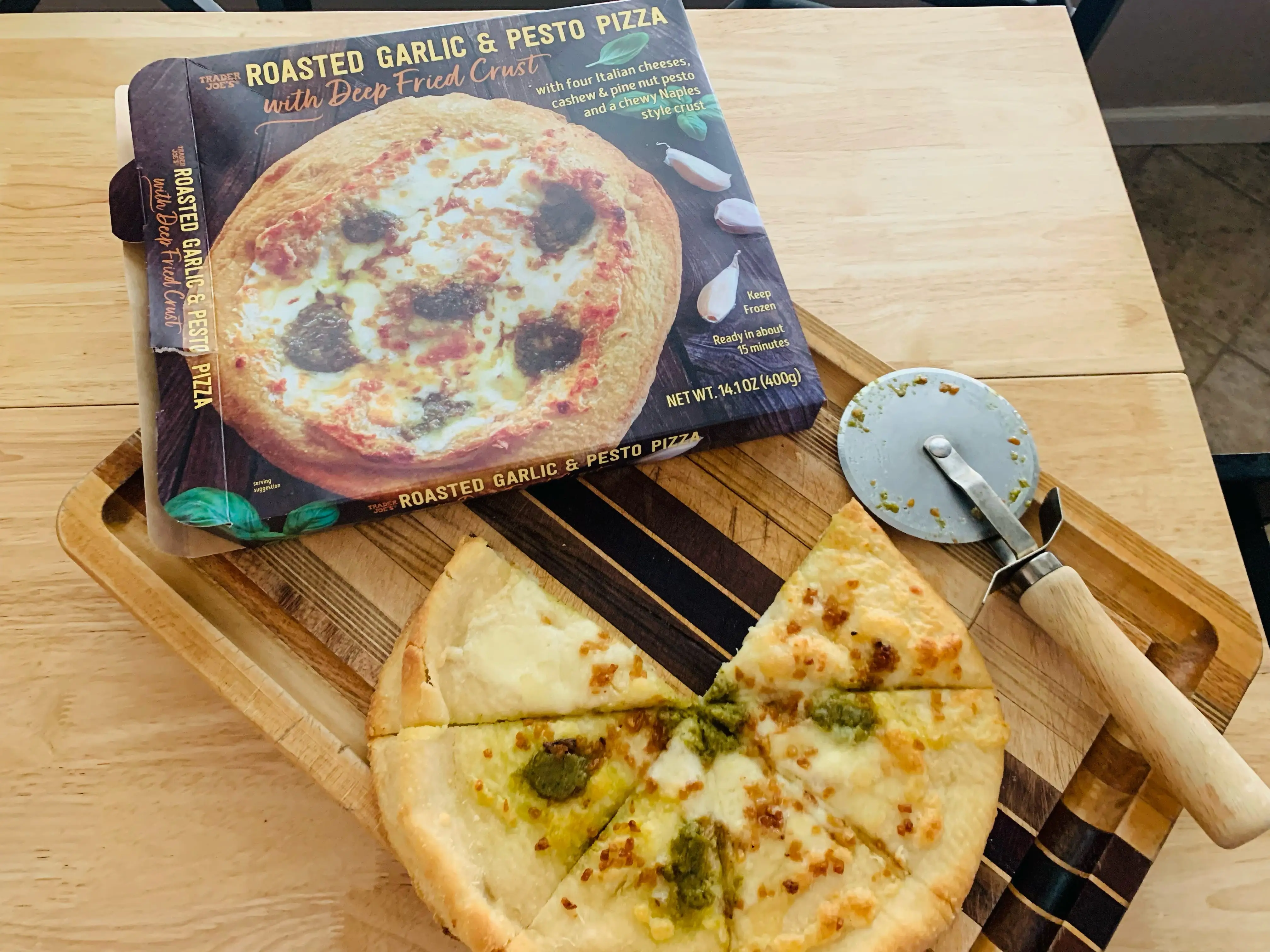 Trader joe's garlic pesto pizza beside original box