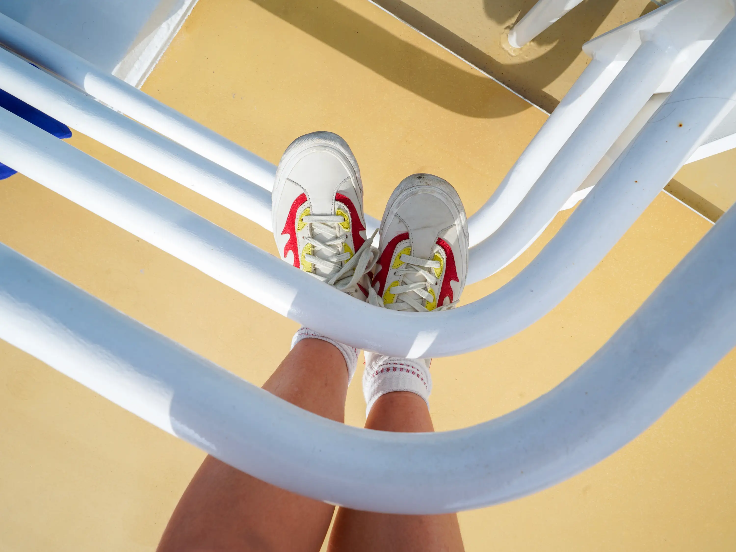The author's sneakers while standing on a railing on the ship