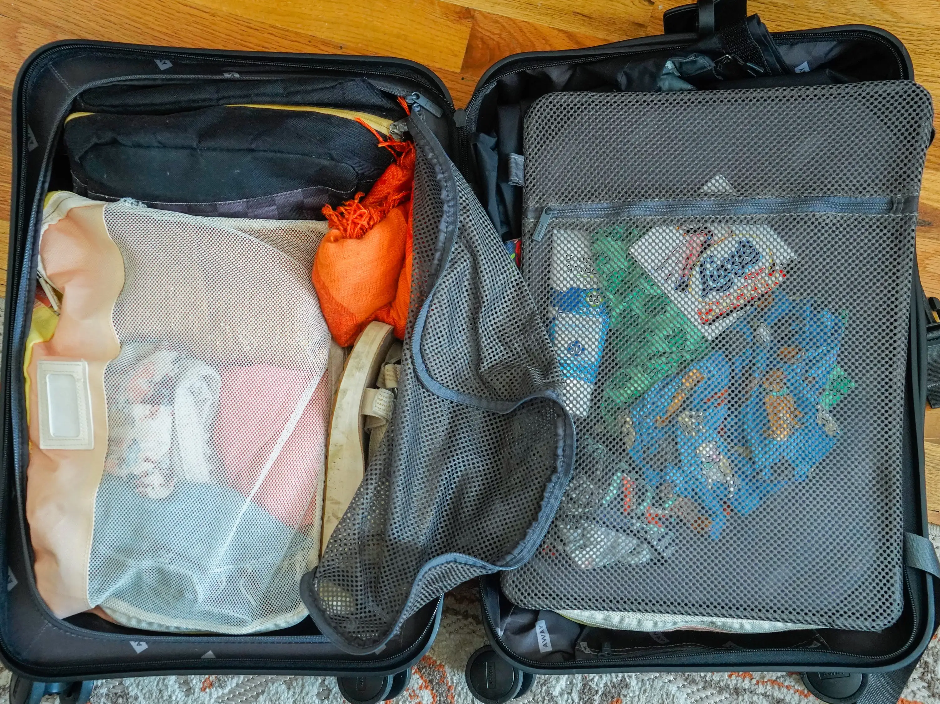 An Insider author's packed suitcase opened with the mesh unzipped.