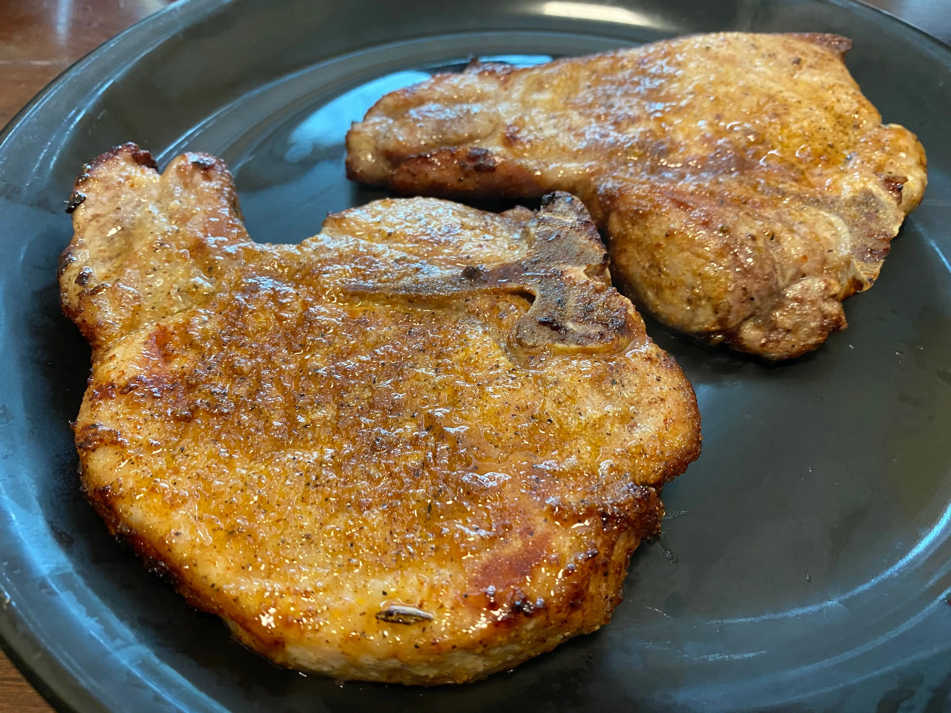 A photo of cooked pork chops on a plate