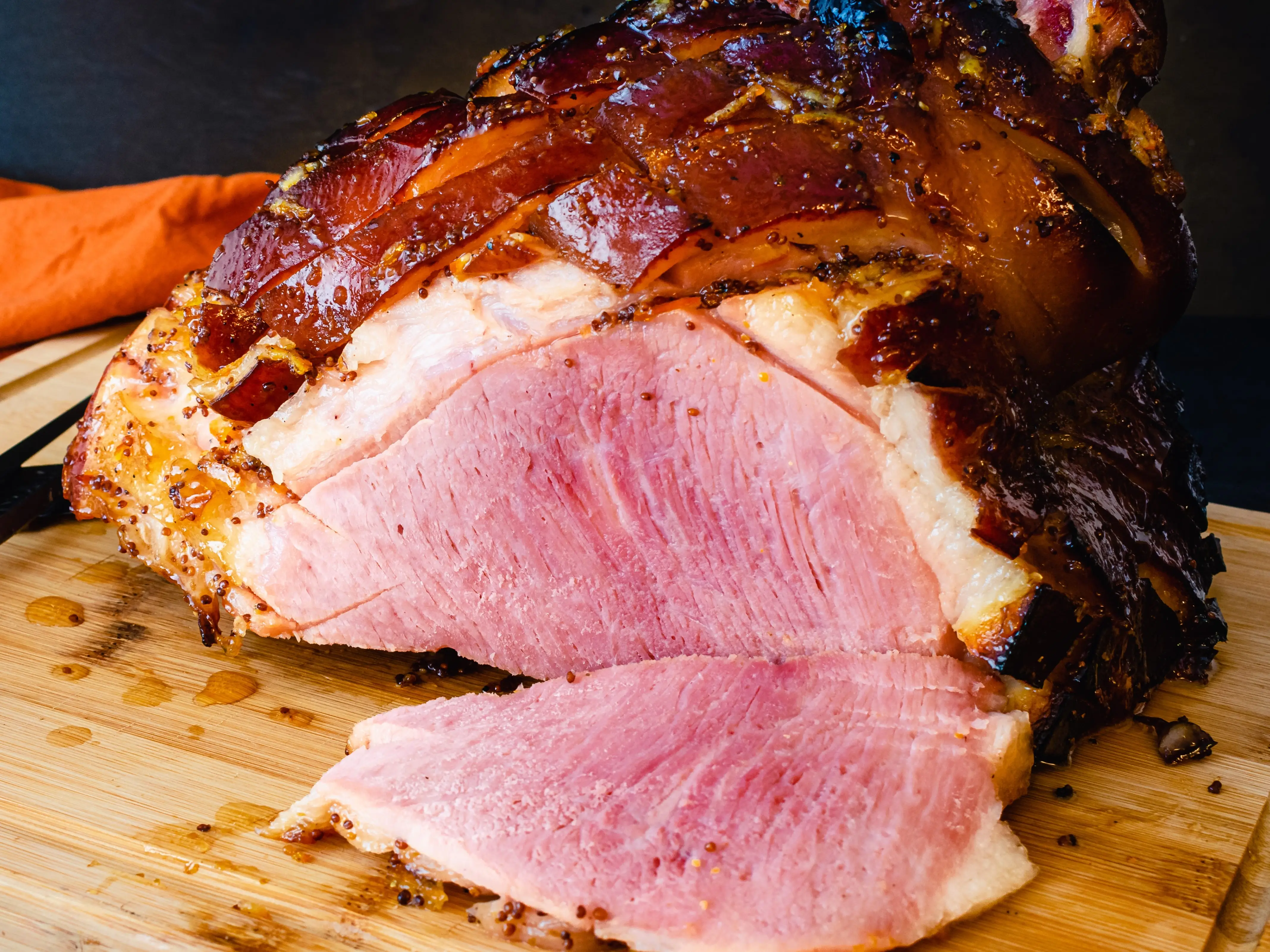 Ham being sliced on a cutting board