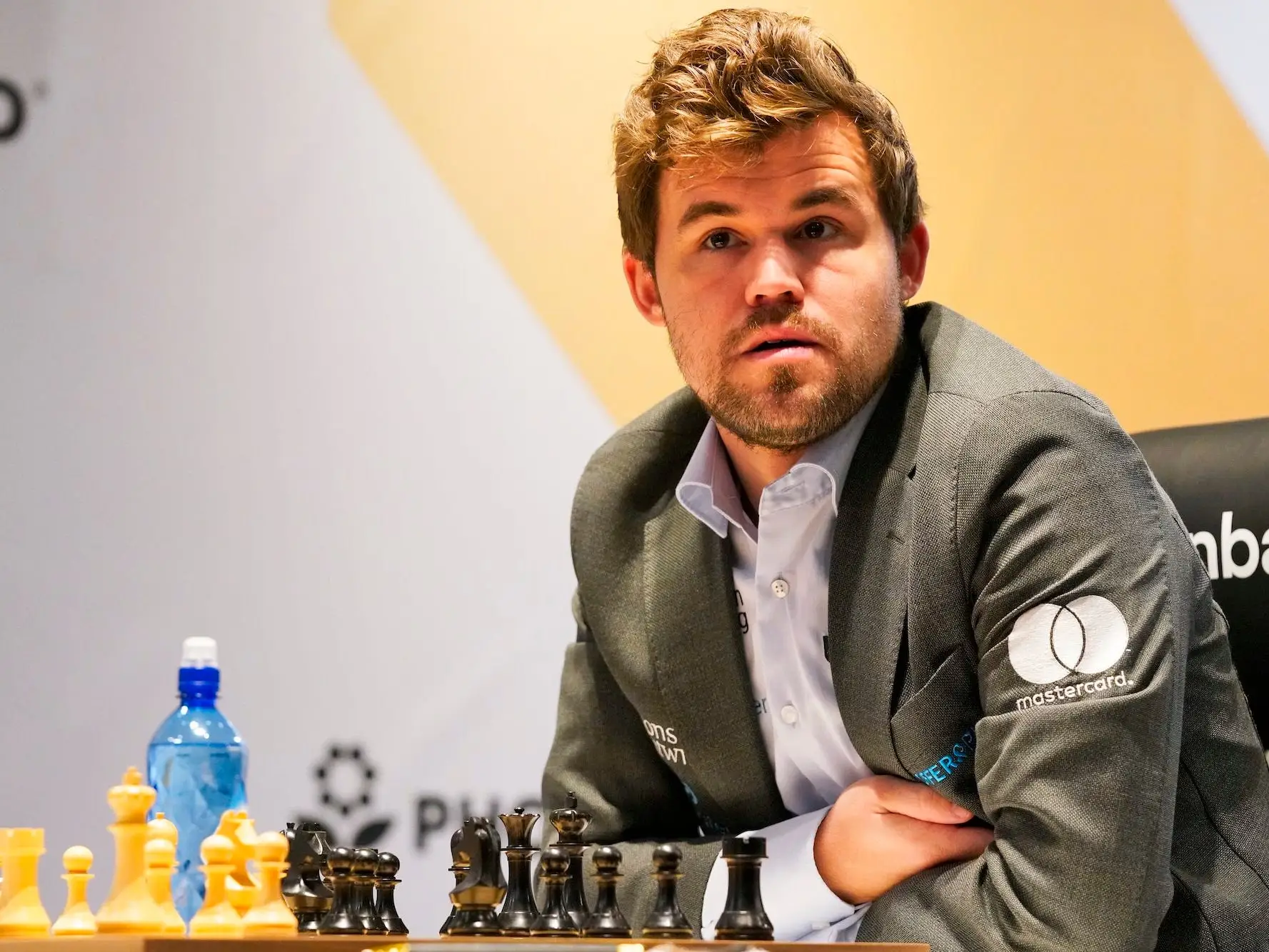 Magnus Carlsen looks up from the chess board during a match in 2021.