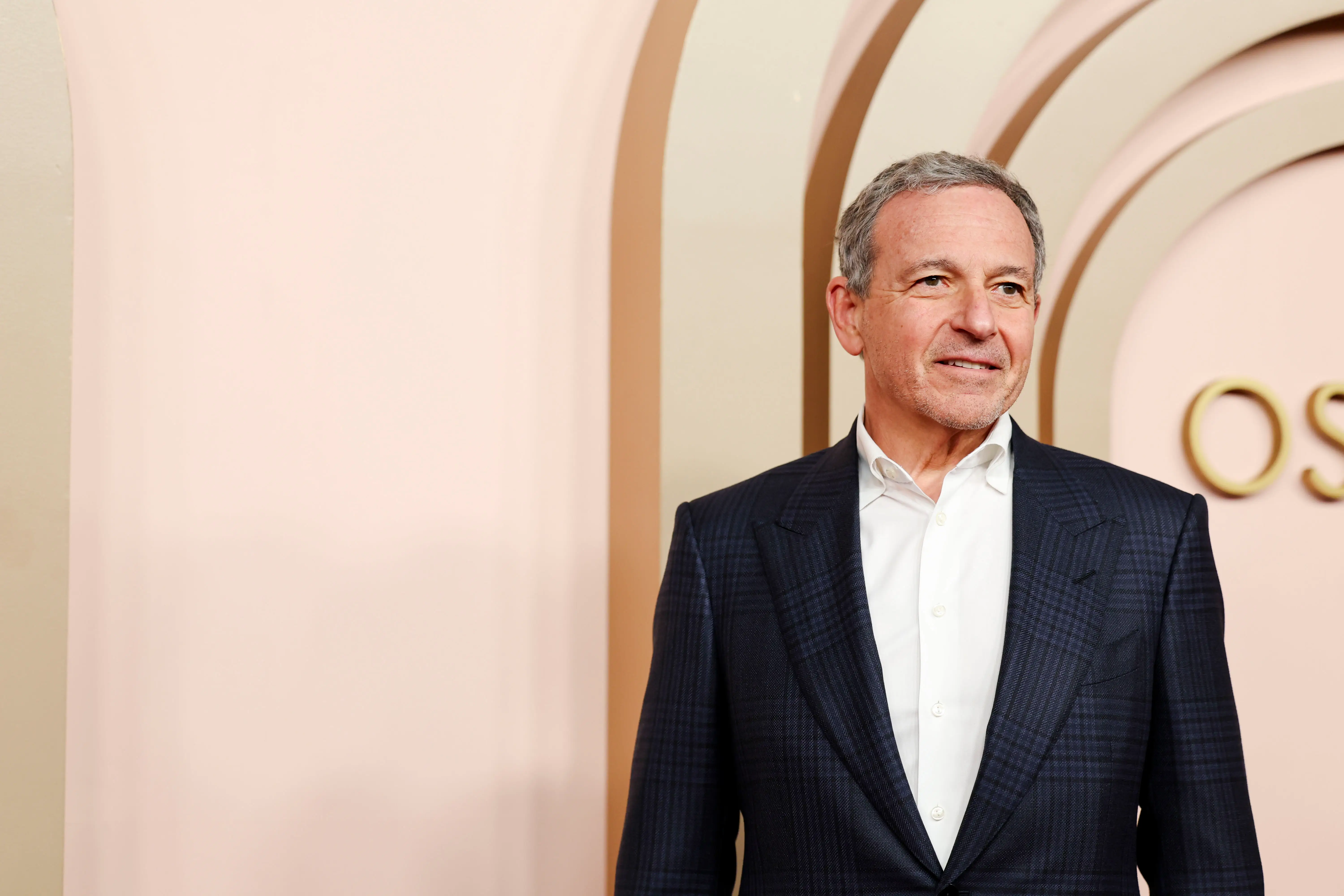 Bob Iger smiles while wearing a suit without a tie.