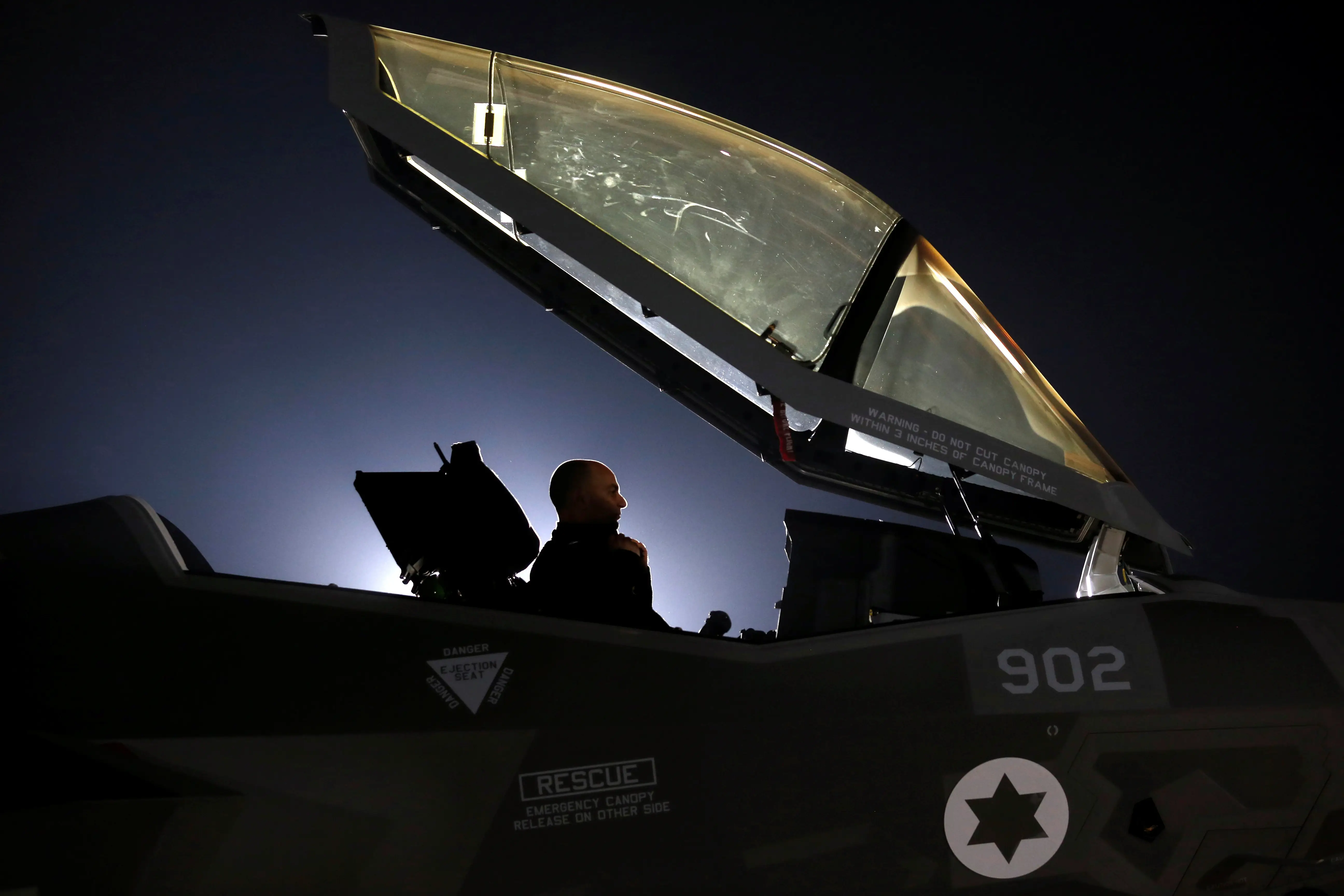 An Israeli soldier sits inside a F-35 fighter jet