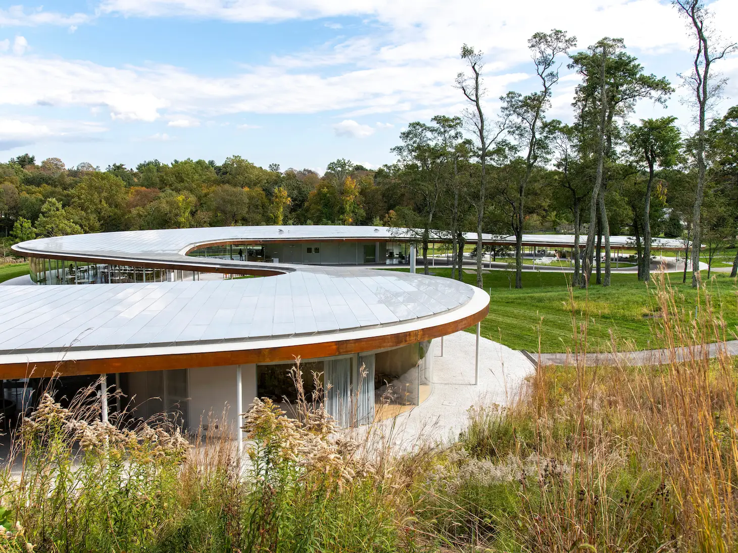 A large winding building and gardens at Grace Farms in Connecticut.