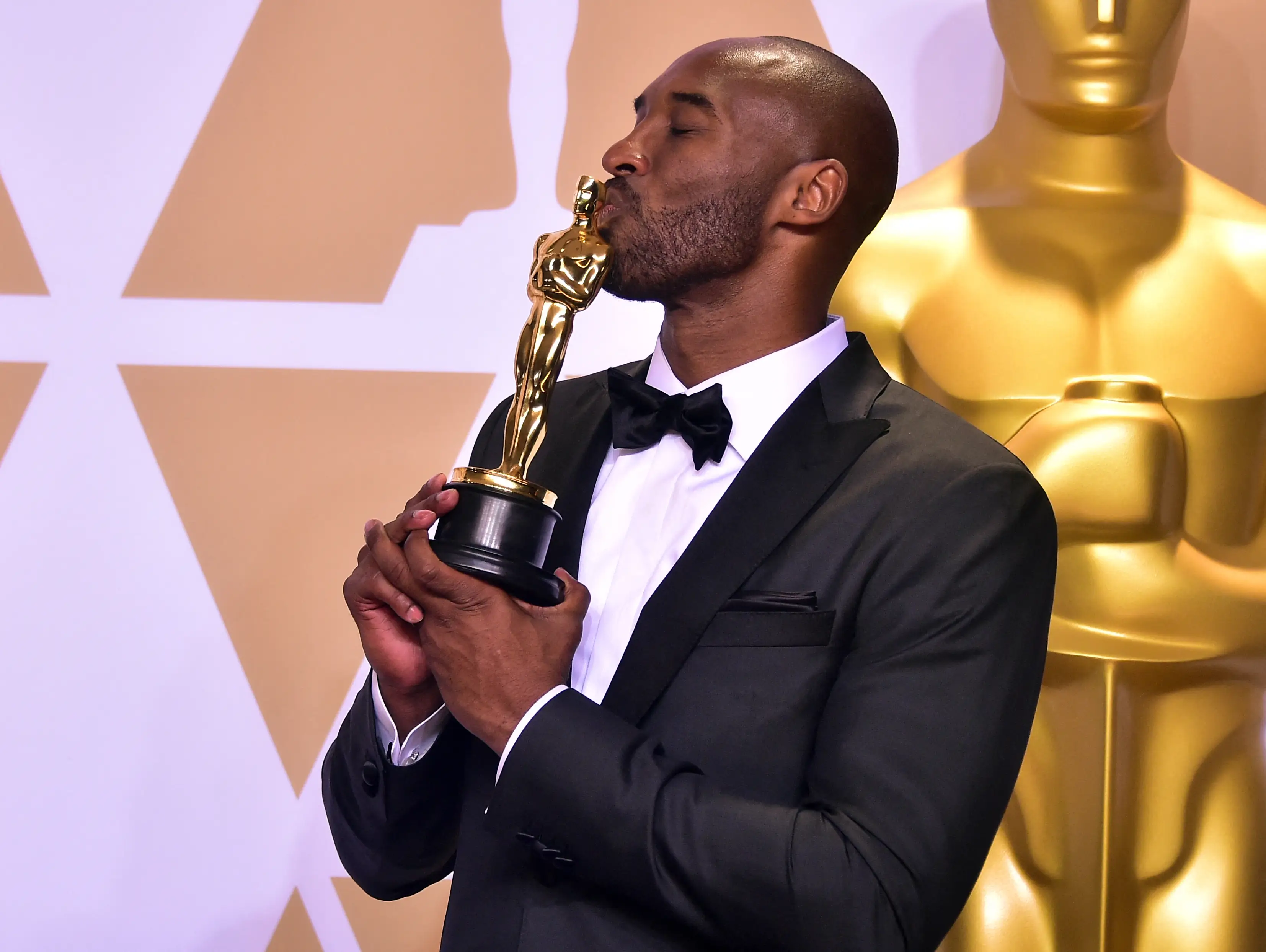 Kobe Bryant poses in the press room with the Oscar for Best Animated Short Film for