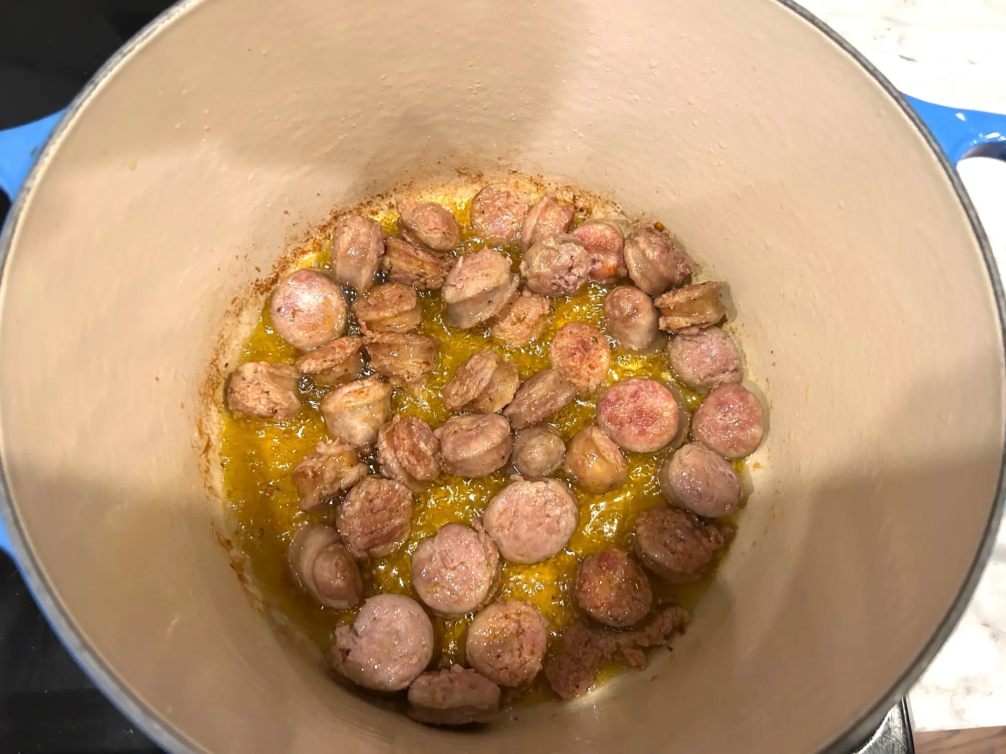 Adding sausage to pot for Ina Garten's sausage orecchiette
