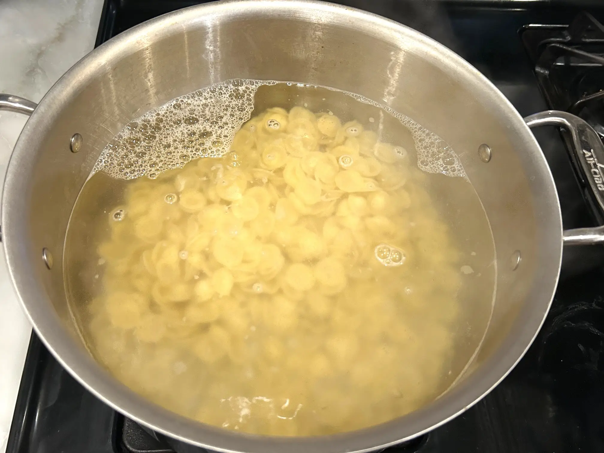 Boiling pasta for Ina Garten's sausage orecchiette