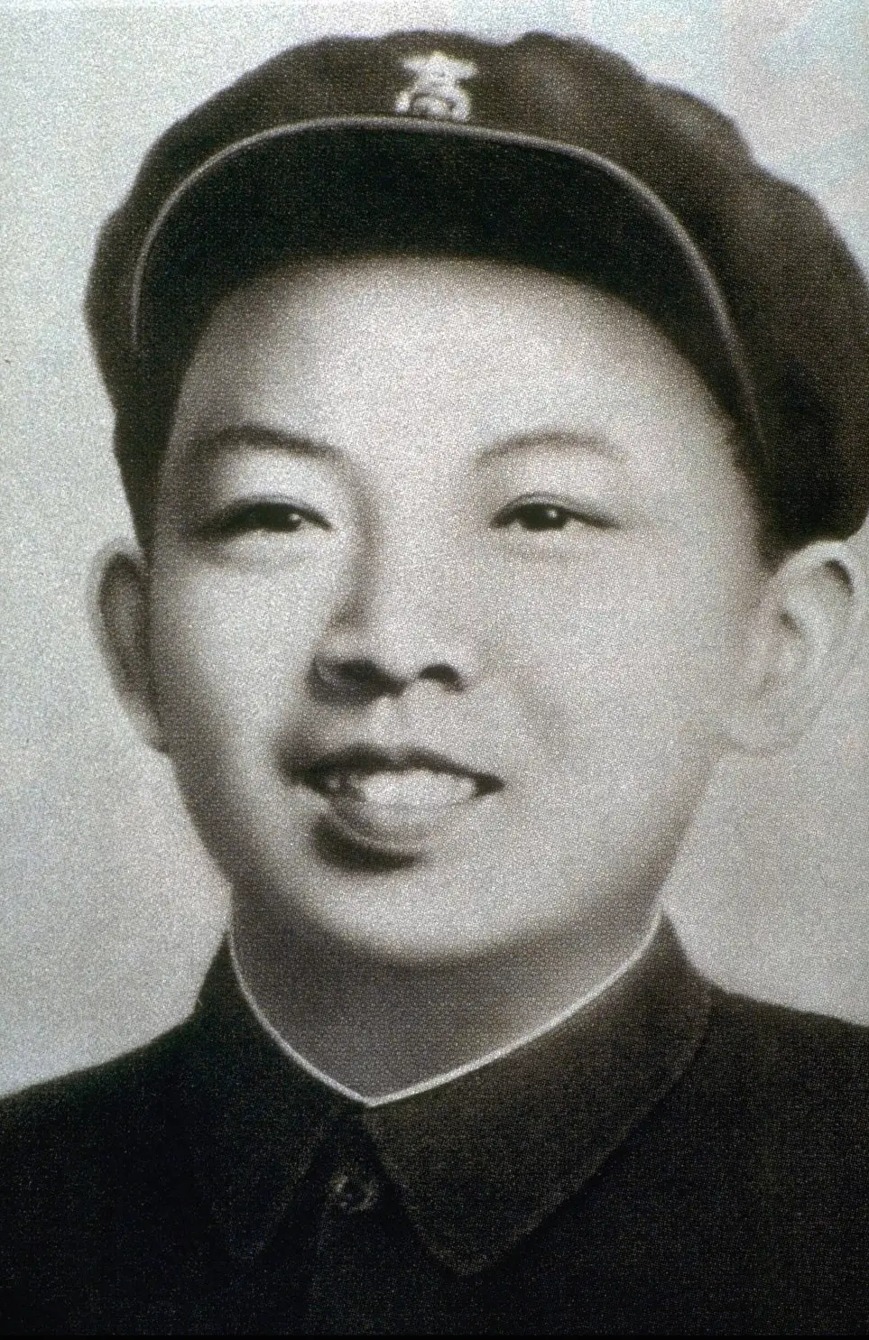 A young Kim Jong Il wearing a military cap