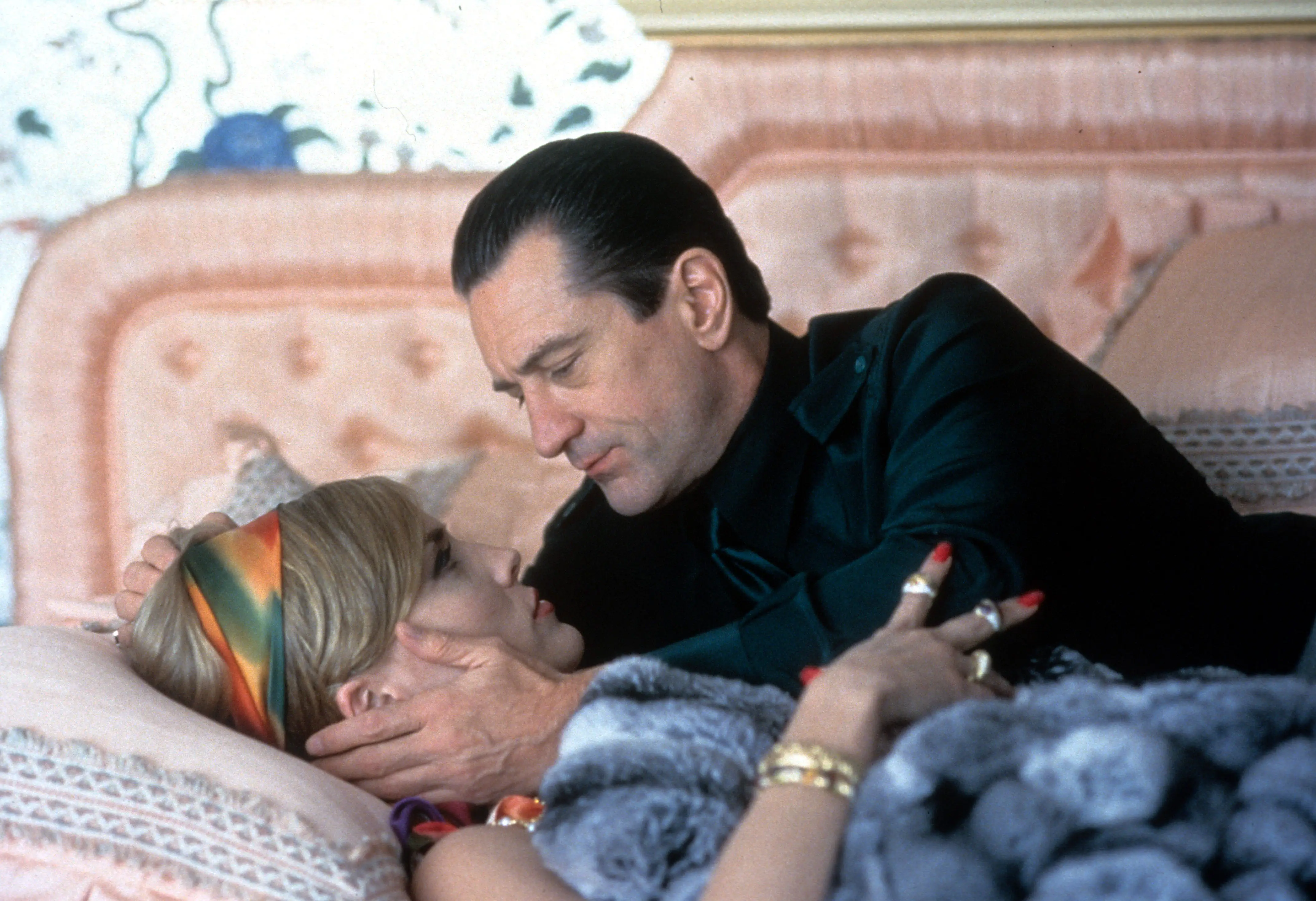 Robert De Niro holding Sharon Stone on a bed