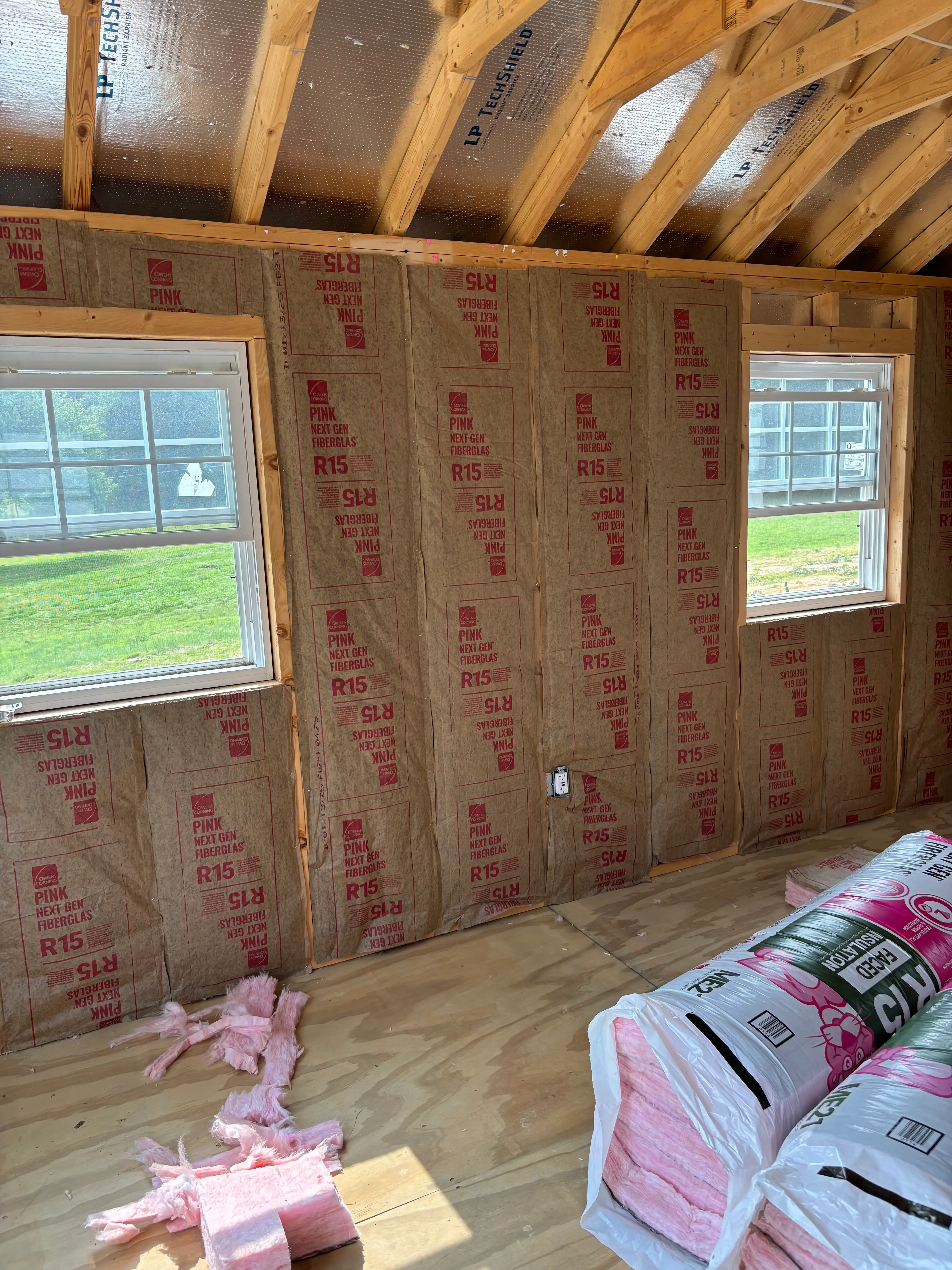 The interior of a shed with insulation on the floor.