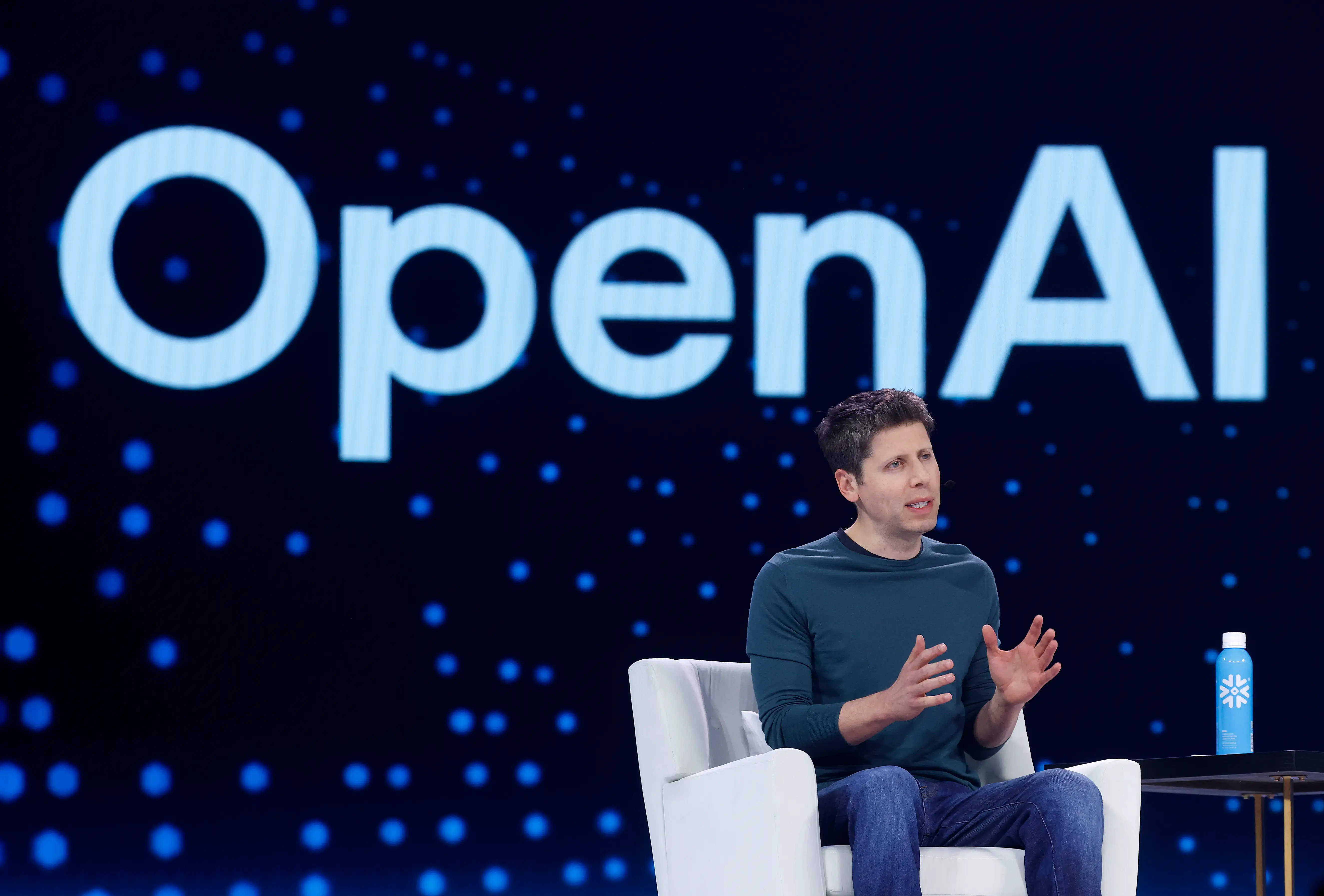 OpenAI CEO Sam Altman on a stage.