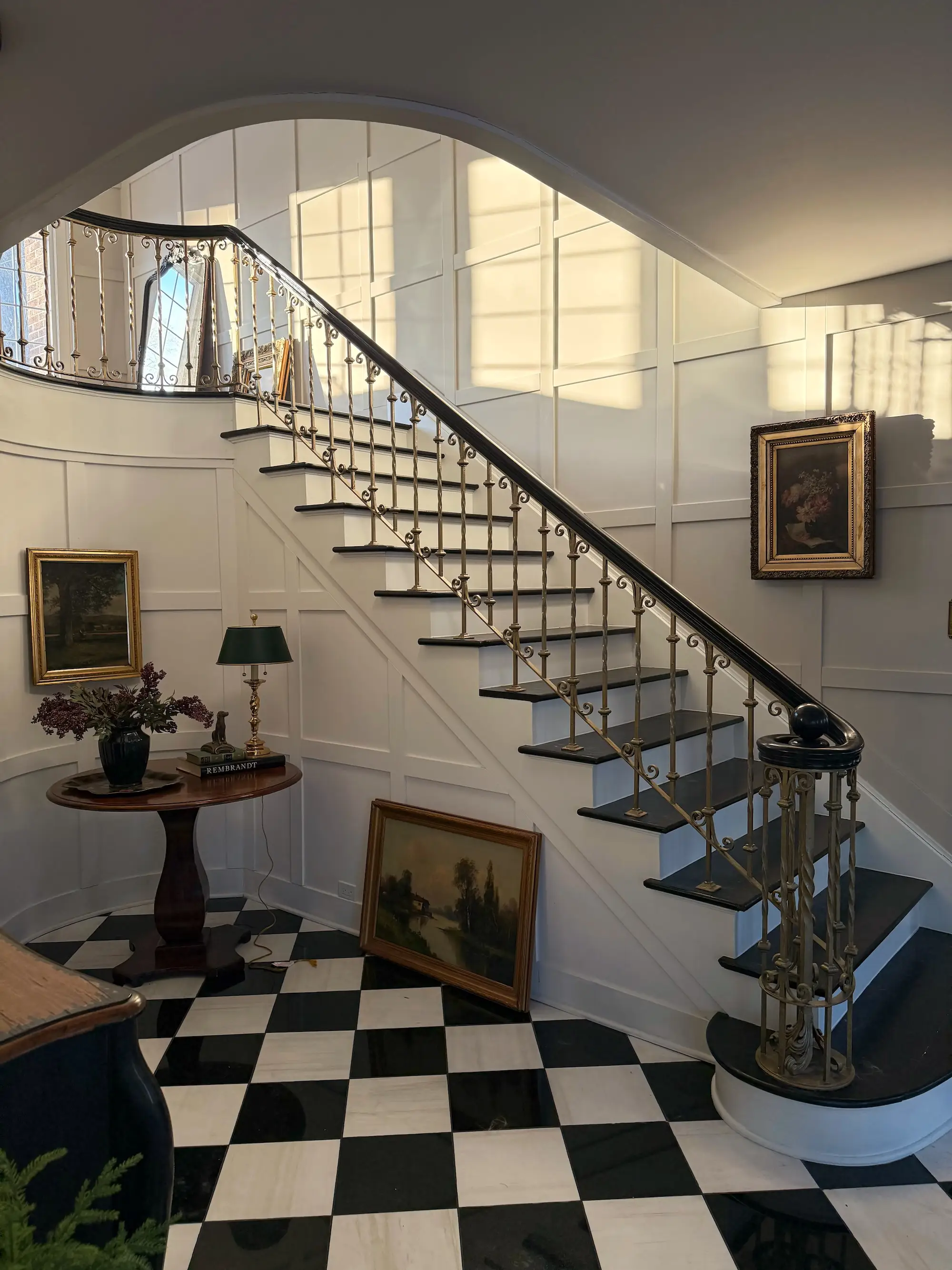 A grand staircase with the sun shining on the walls.