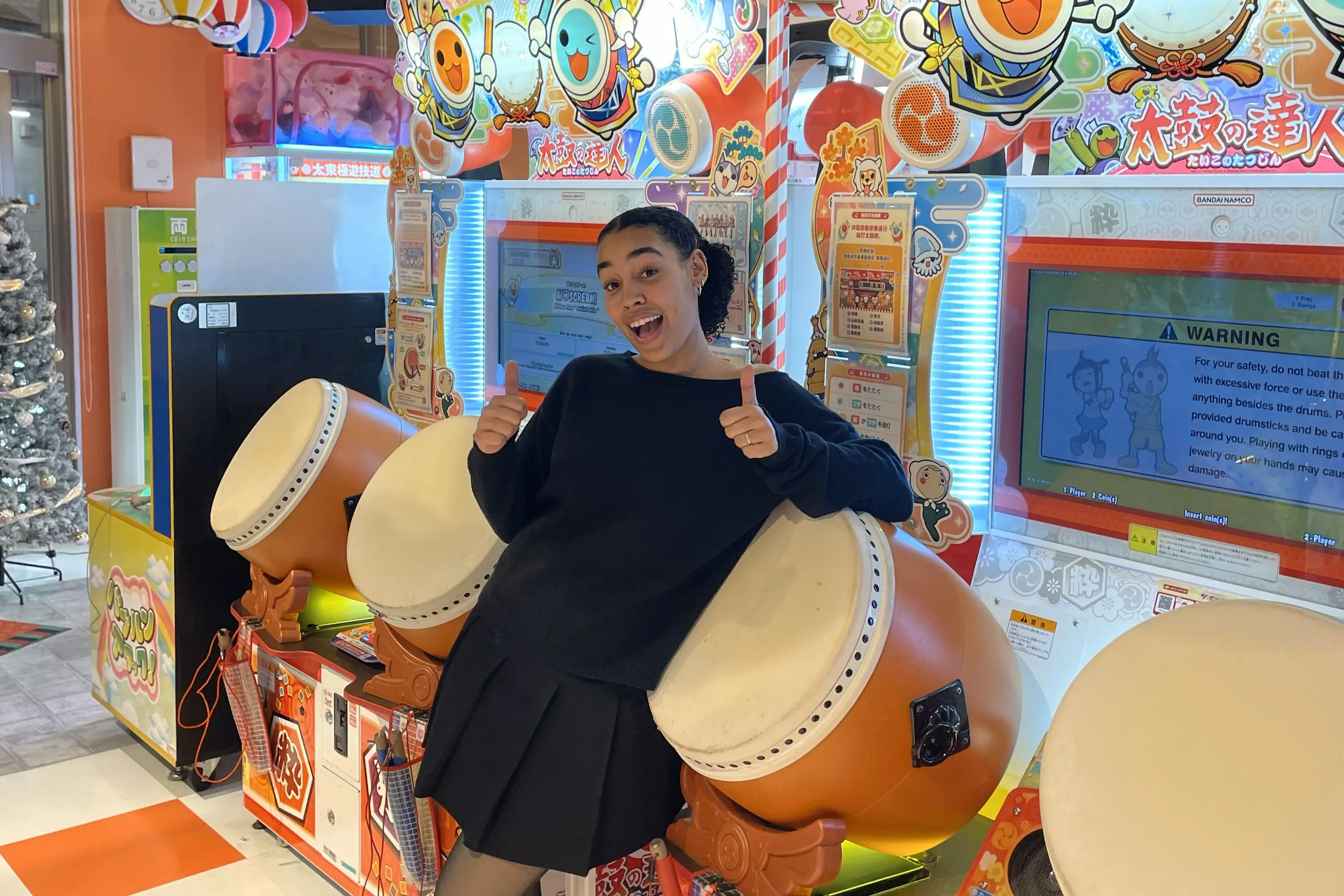 Woman smiling with drum arcade games