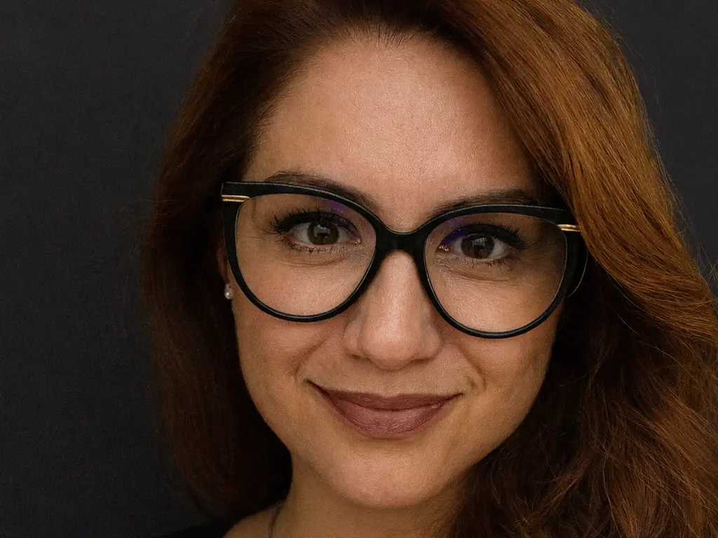 Ayşe Baltacıoğlu-Brammer poses for camera against grey backdrop