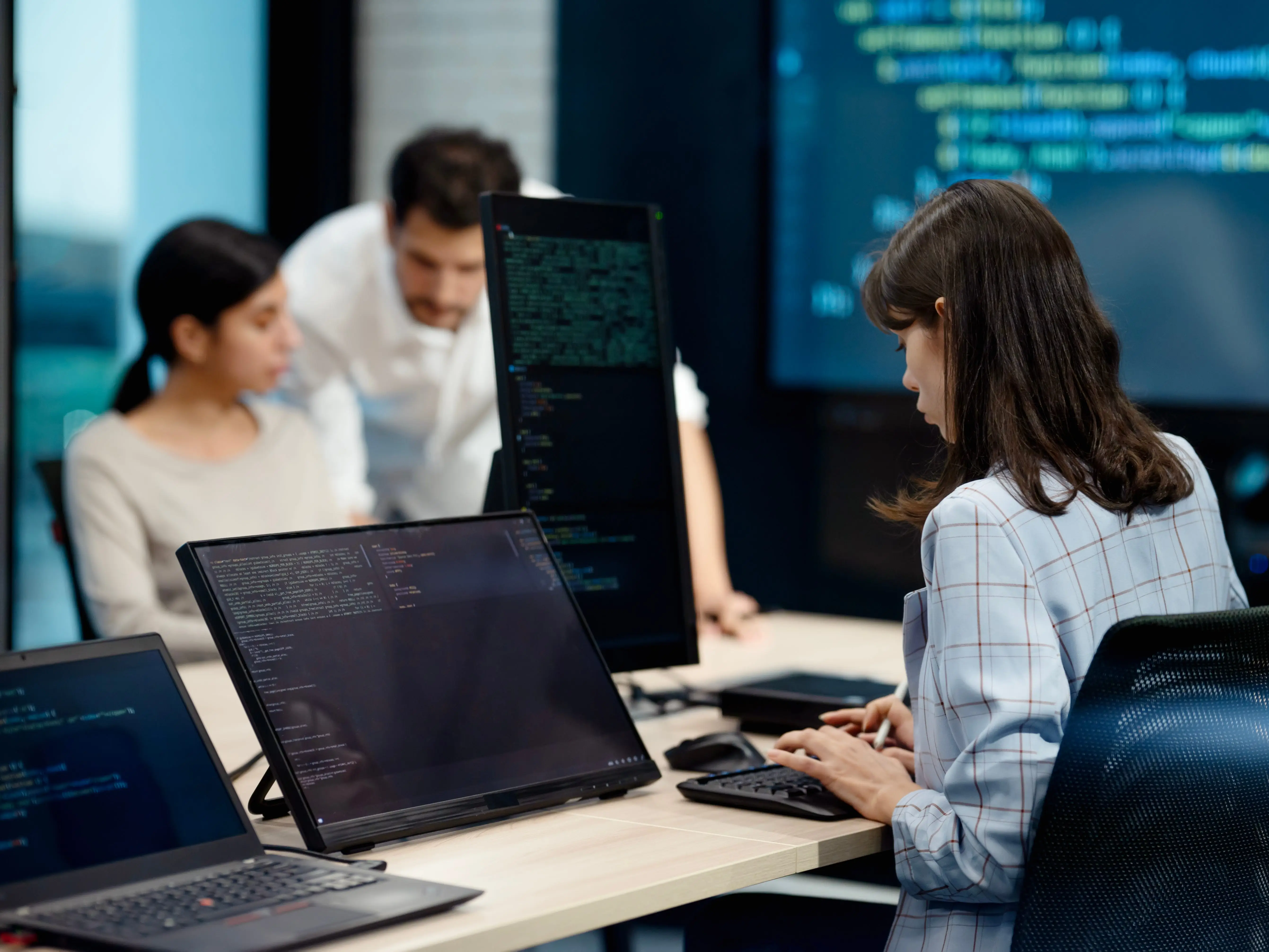 People working on or looking at computer code