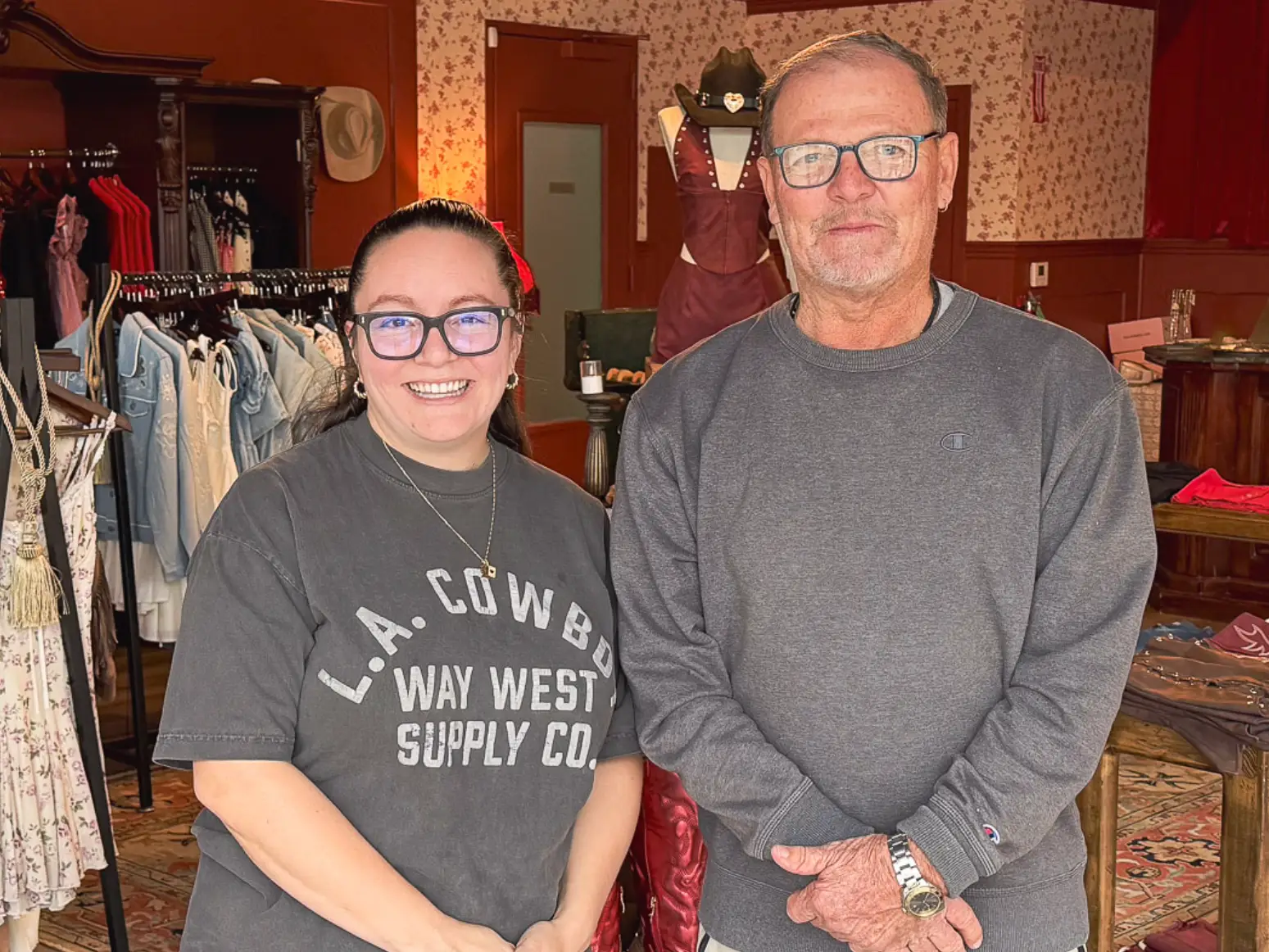 The writer and her neighbor Chris standing in her boutique.