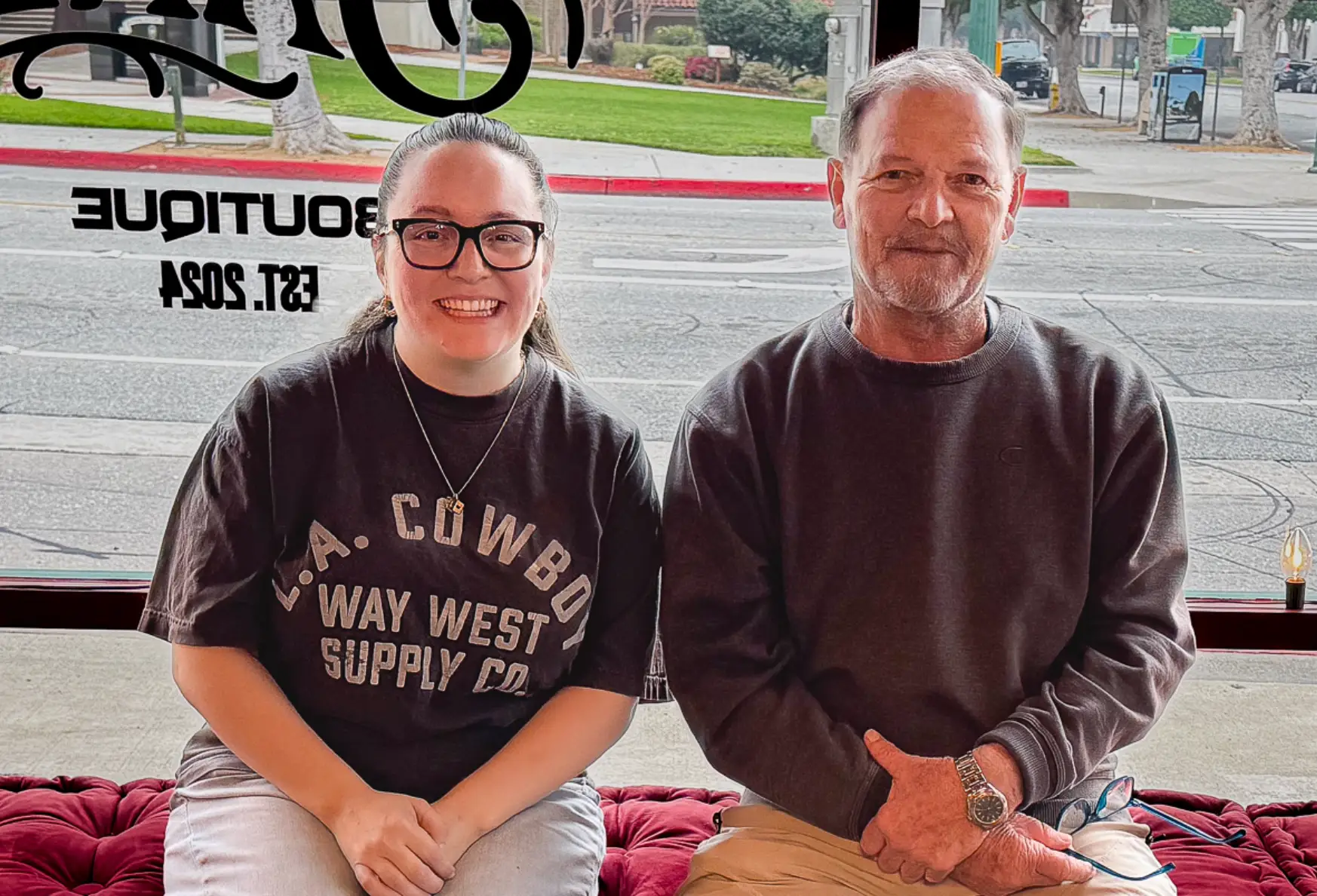 The writer and her neighbor sitting on a bench at her store.