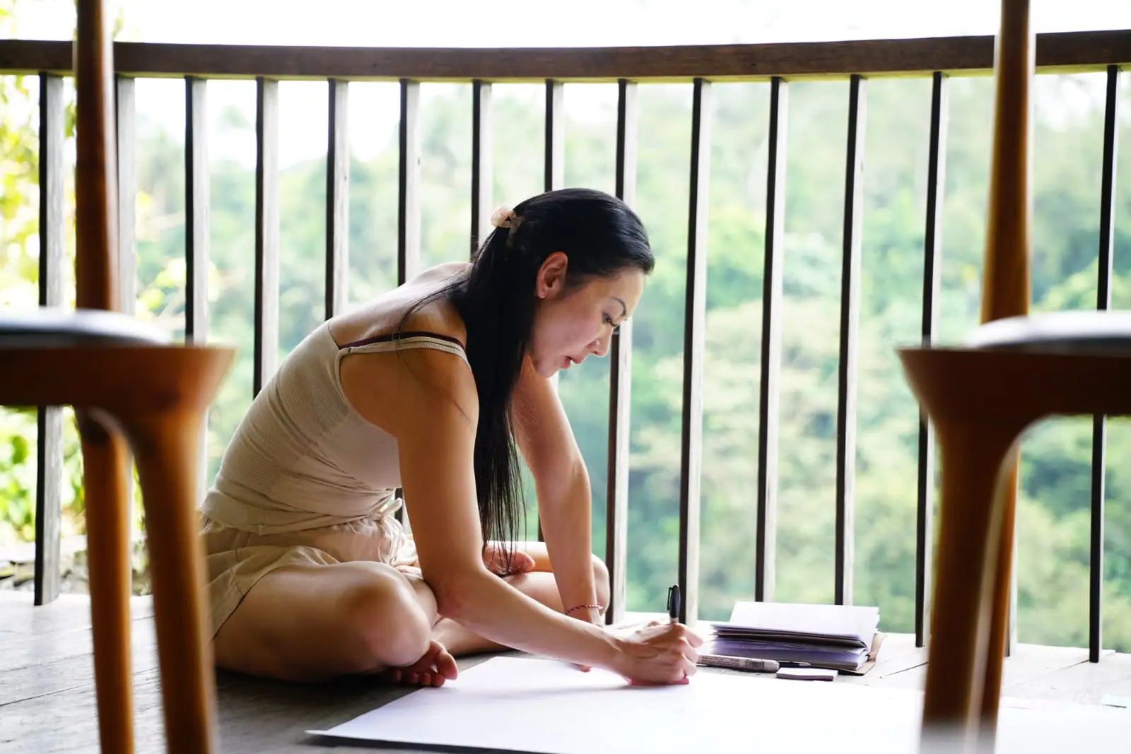 Friska Wirya crossed legged on a balcony