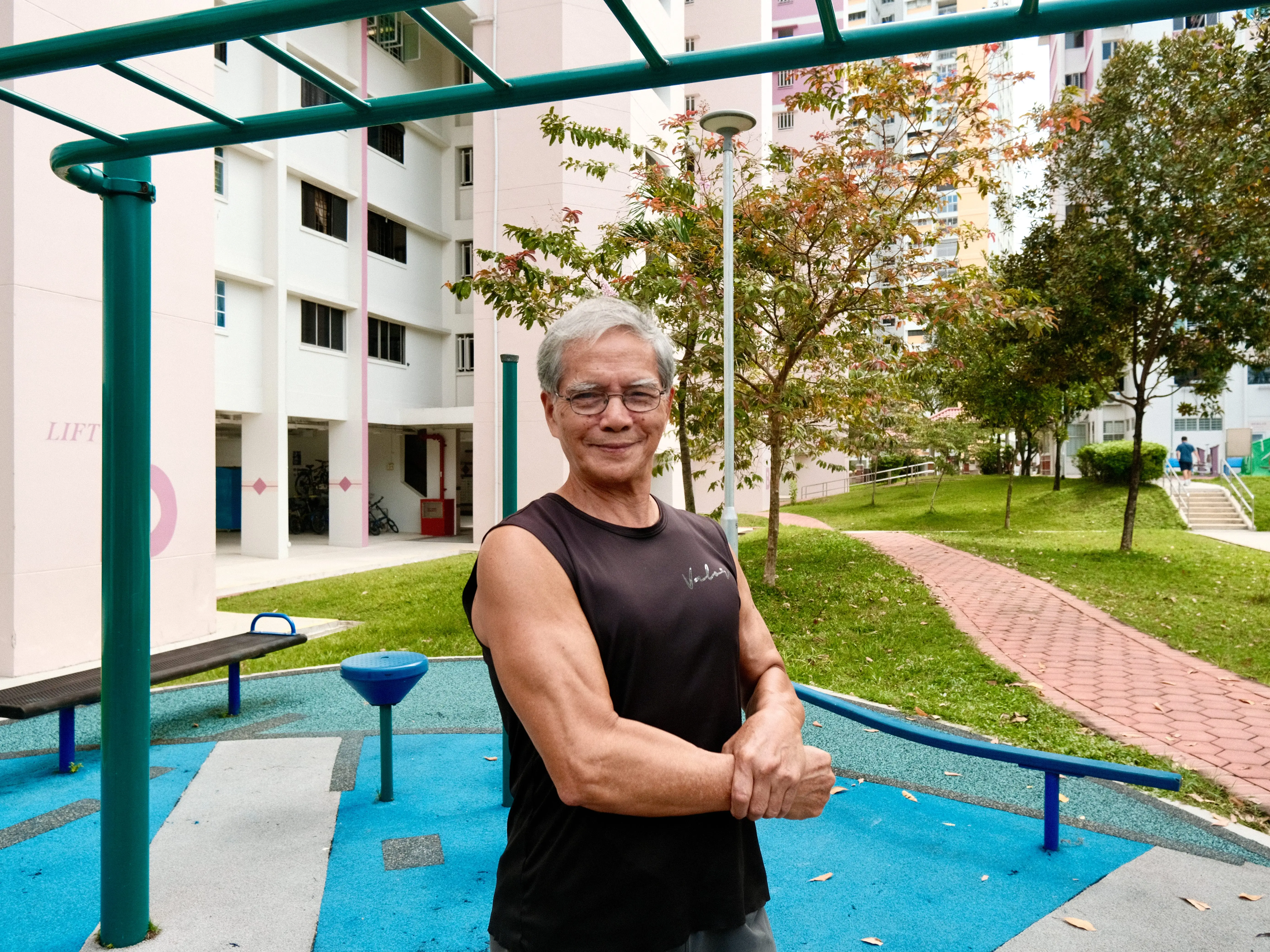 A man flexing at a fitness corner in Singapore.